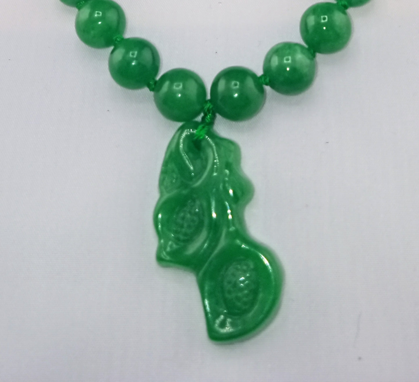 green jade necklace with carved green jade orchid