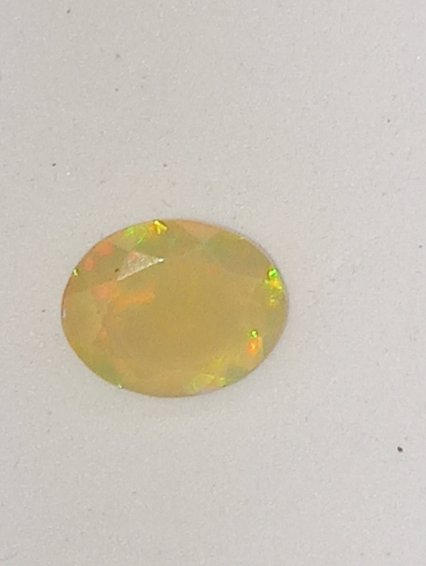 opal Ethiopian oval, 12mmx10mm faceted, orange flash, 1.75ct