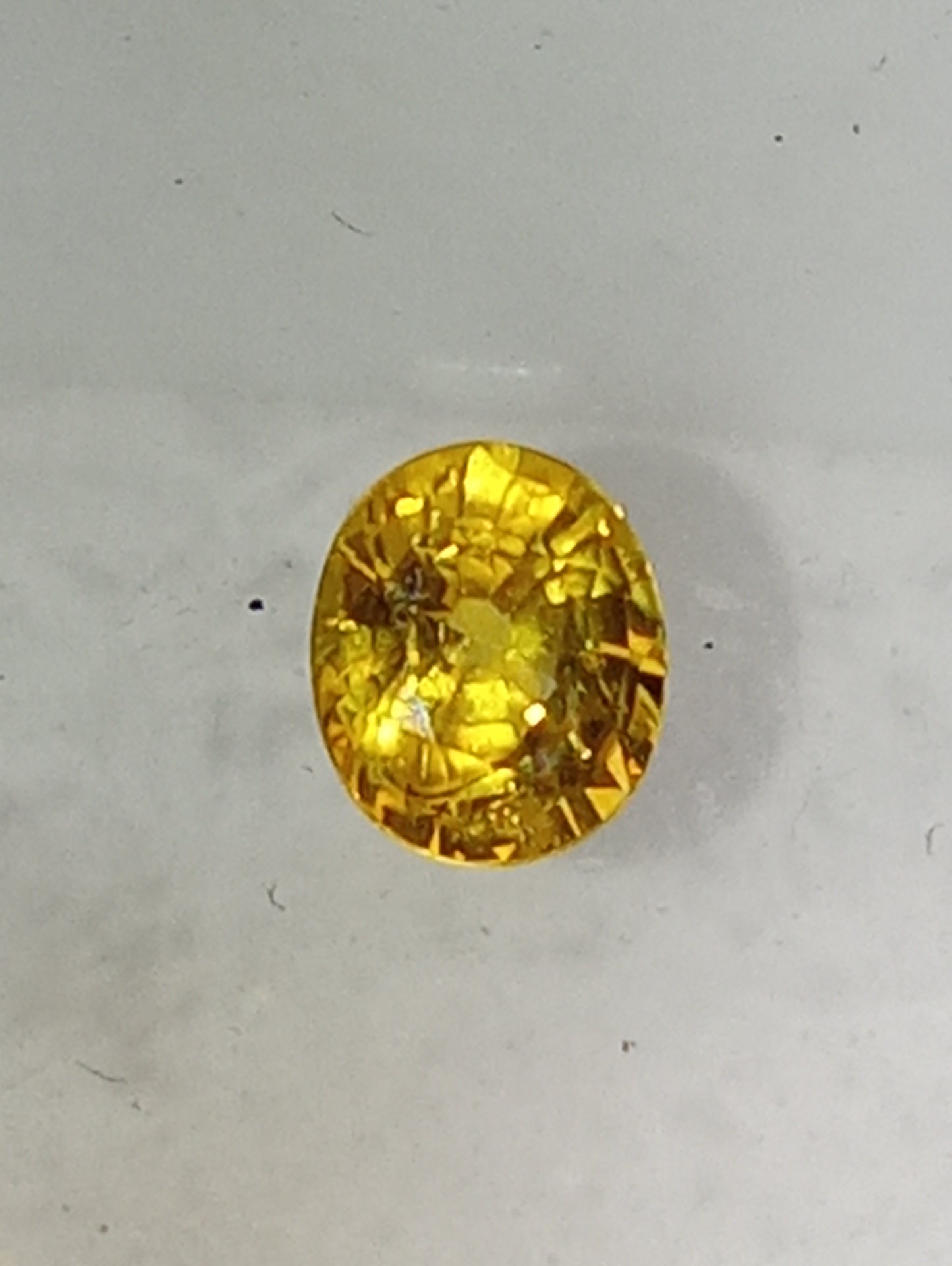 sapphire gemstone, yellow canary, 6mmx5mm oval cut, .71ct