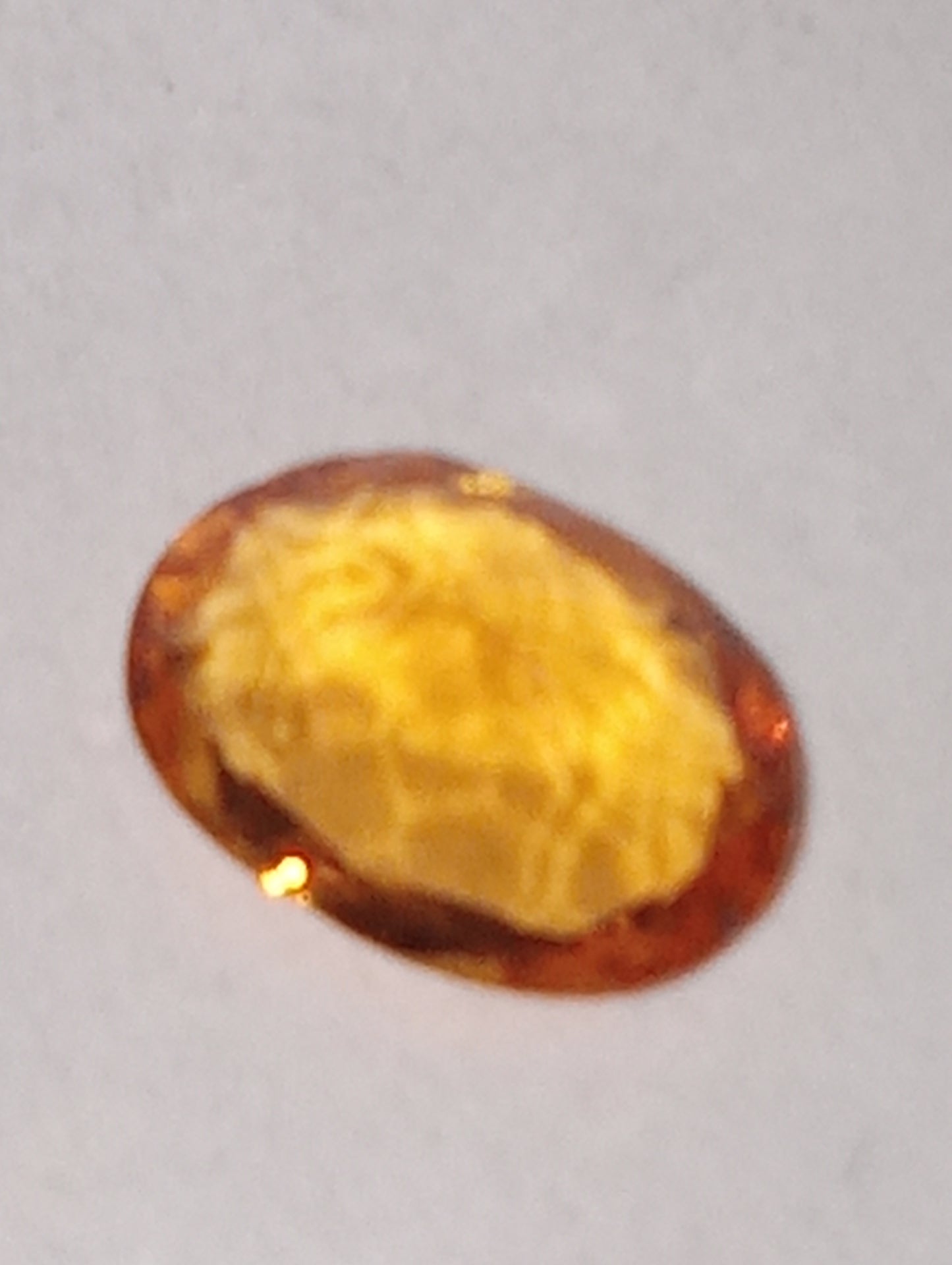 garnet gemstone, mandarin spessartite, 7mmx5mm oval cut, .76ct