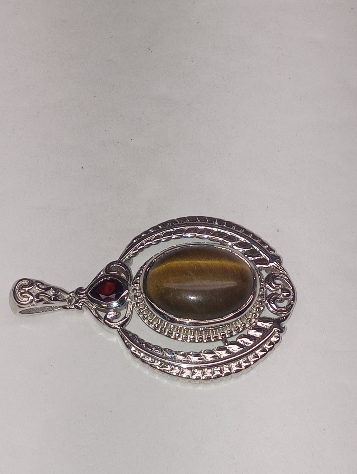 pendant tiger's eye, Mozembique garnet, in platinum over copper with magnet, 10.25ctw