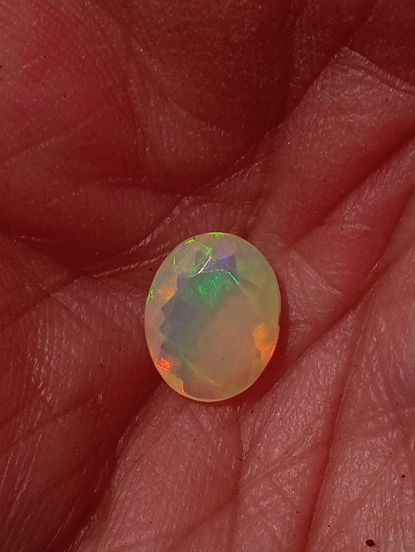 opal gemstone Ethiopian, faceted 10mmx8mm oval cut, 1.09ct