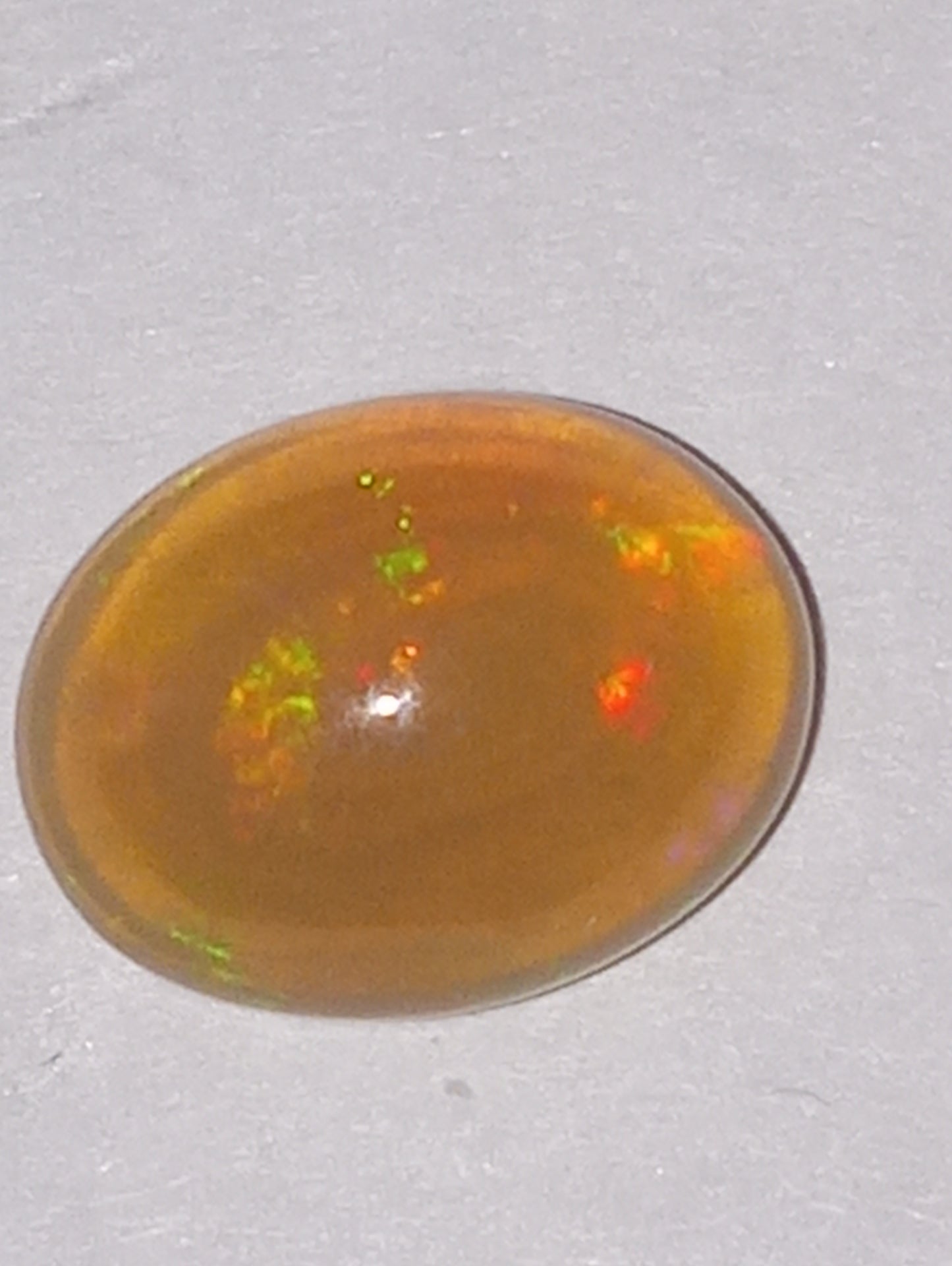 opal gemstone Ethiopian, 9mmx7mm oval, 1.26ct