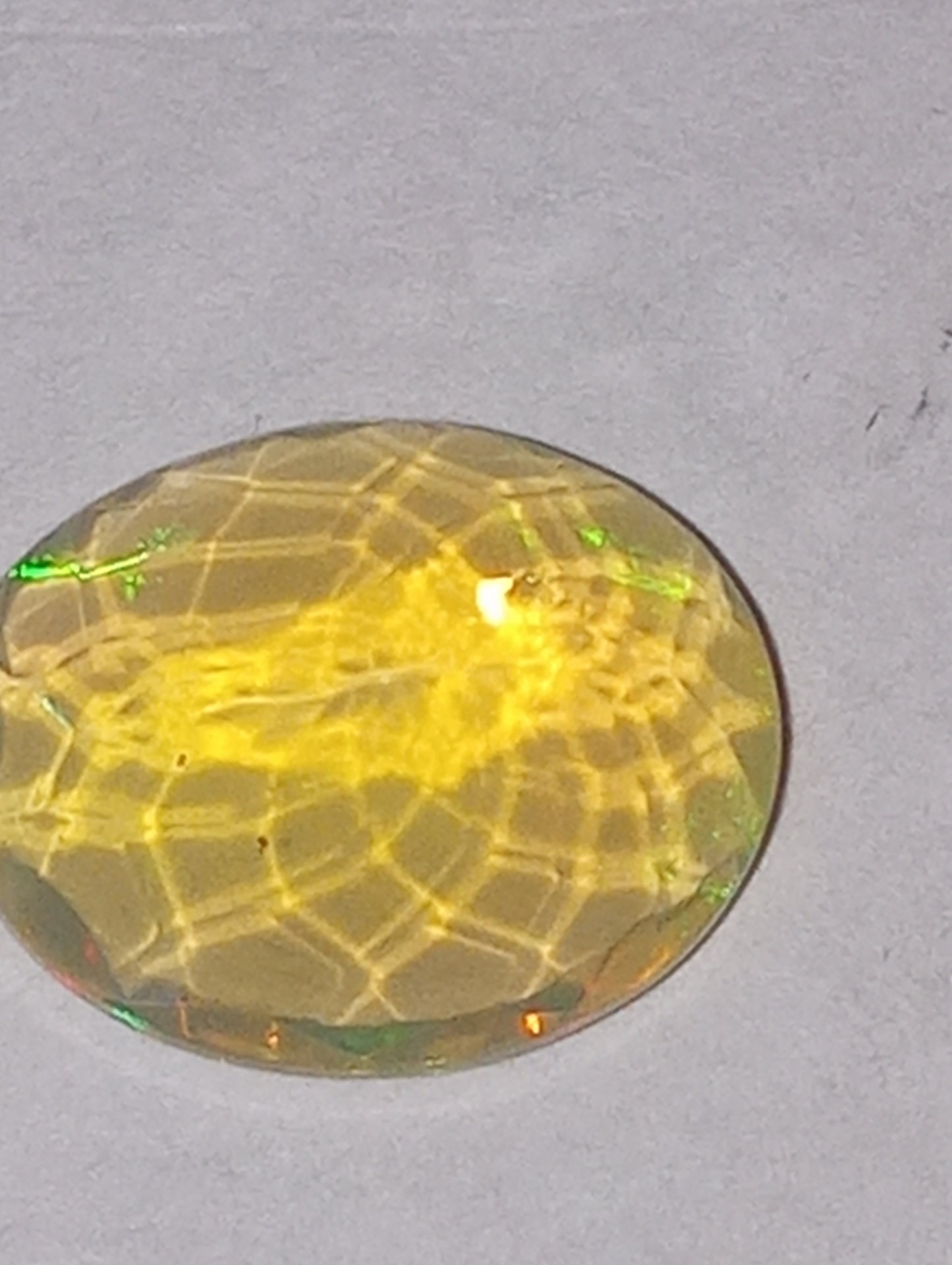 opal gemstone Ethiopian, faceted, 10mmx8mm oval cut, 1.71ct