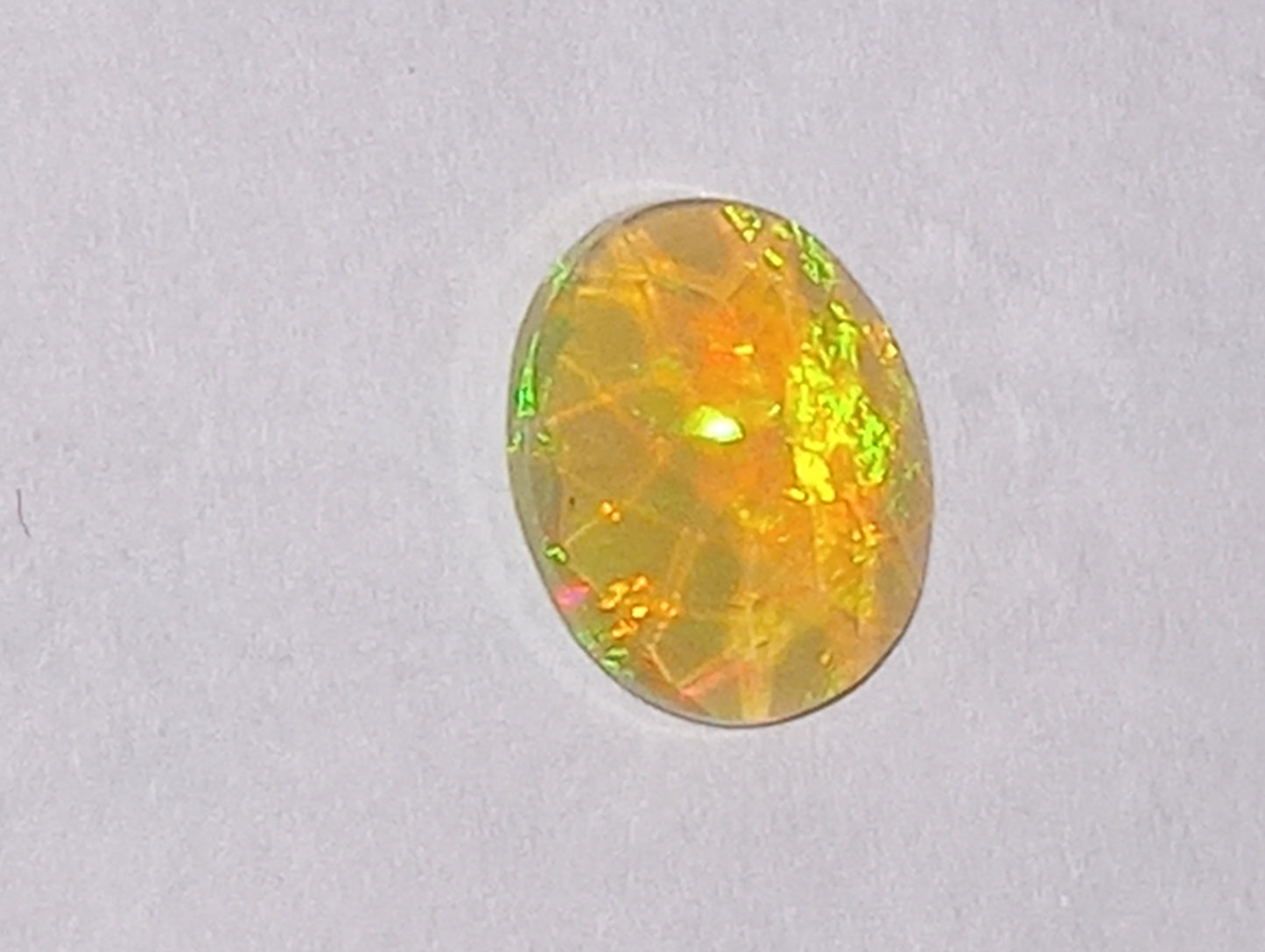 opal gemstone, Ethiopian, faceted, 9mmx7mm oval cut, 1.03ct