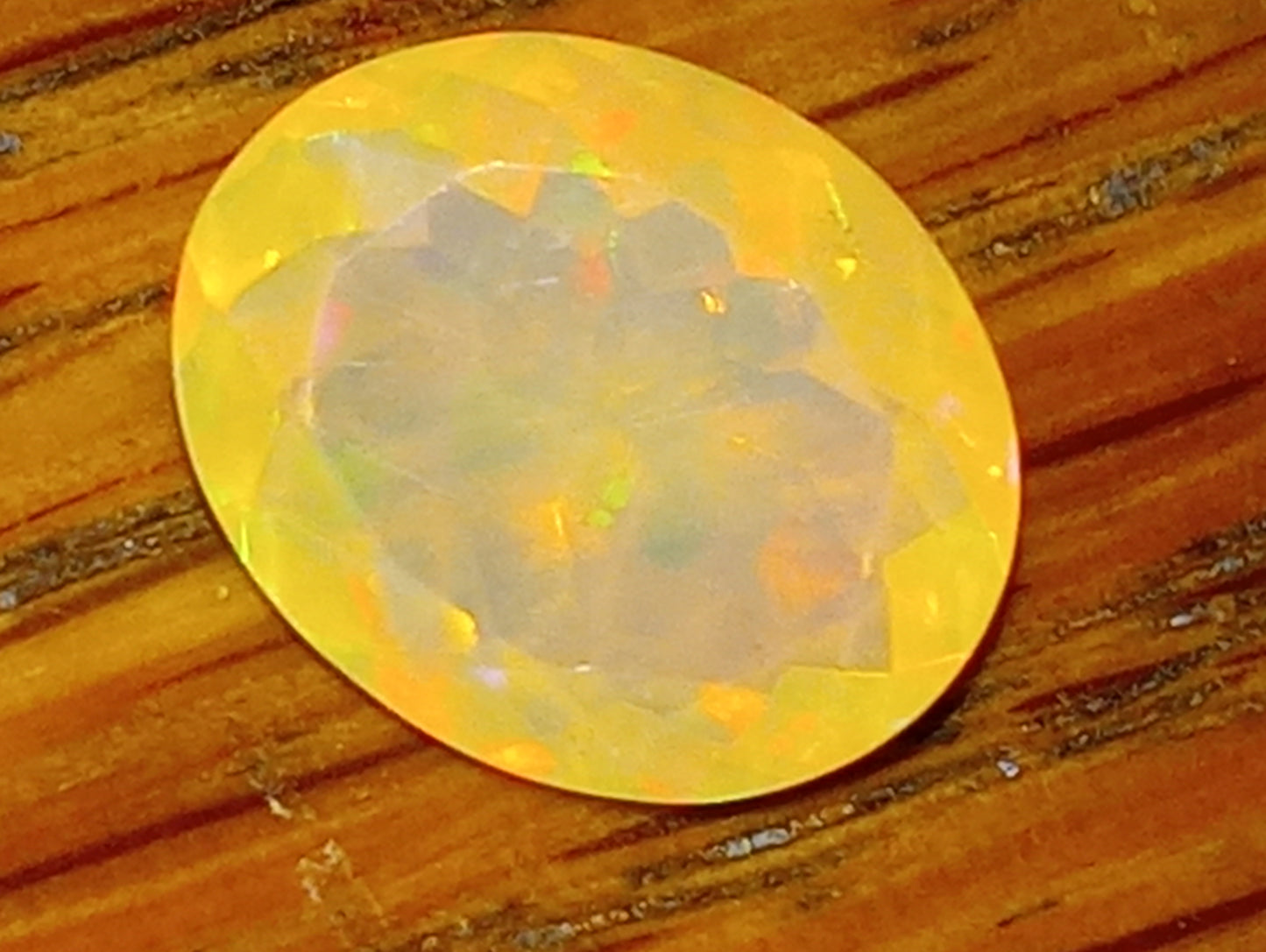 opal gemstone Ethiopian, faceted, 10mm x8mm oval, 1.53ct