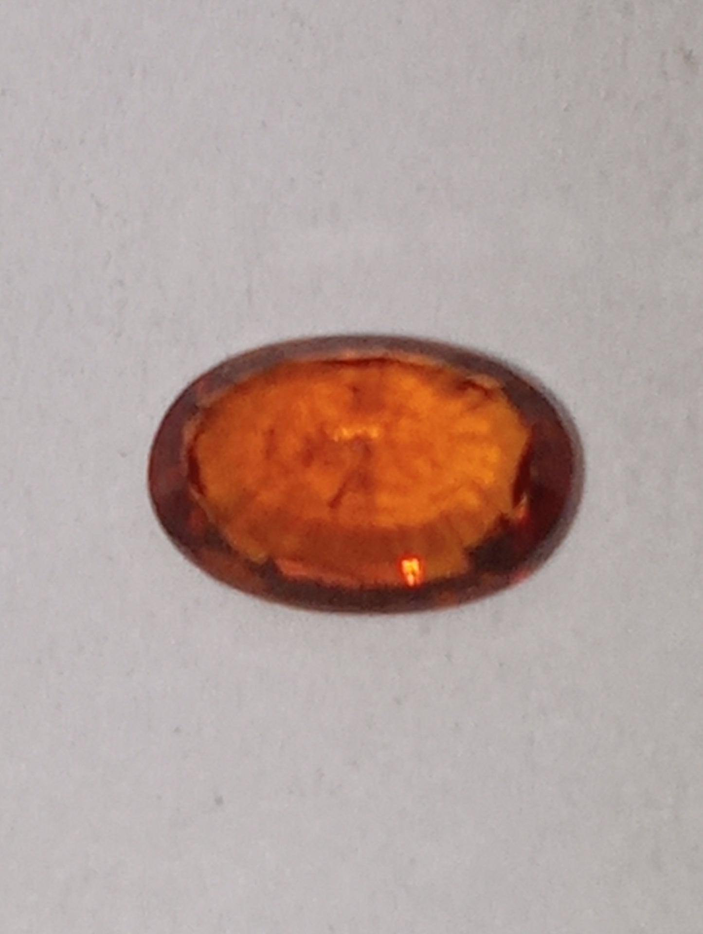 garnet gemstone Spessartite, 6mm x4mm oval cut, .62ct