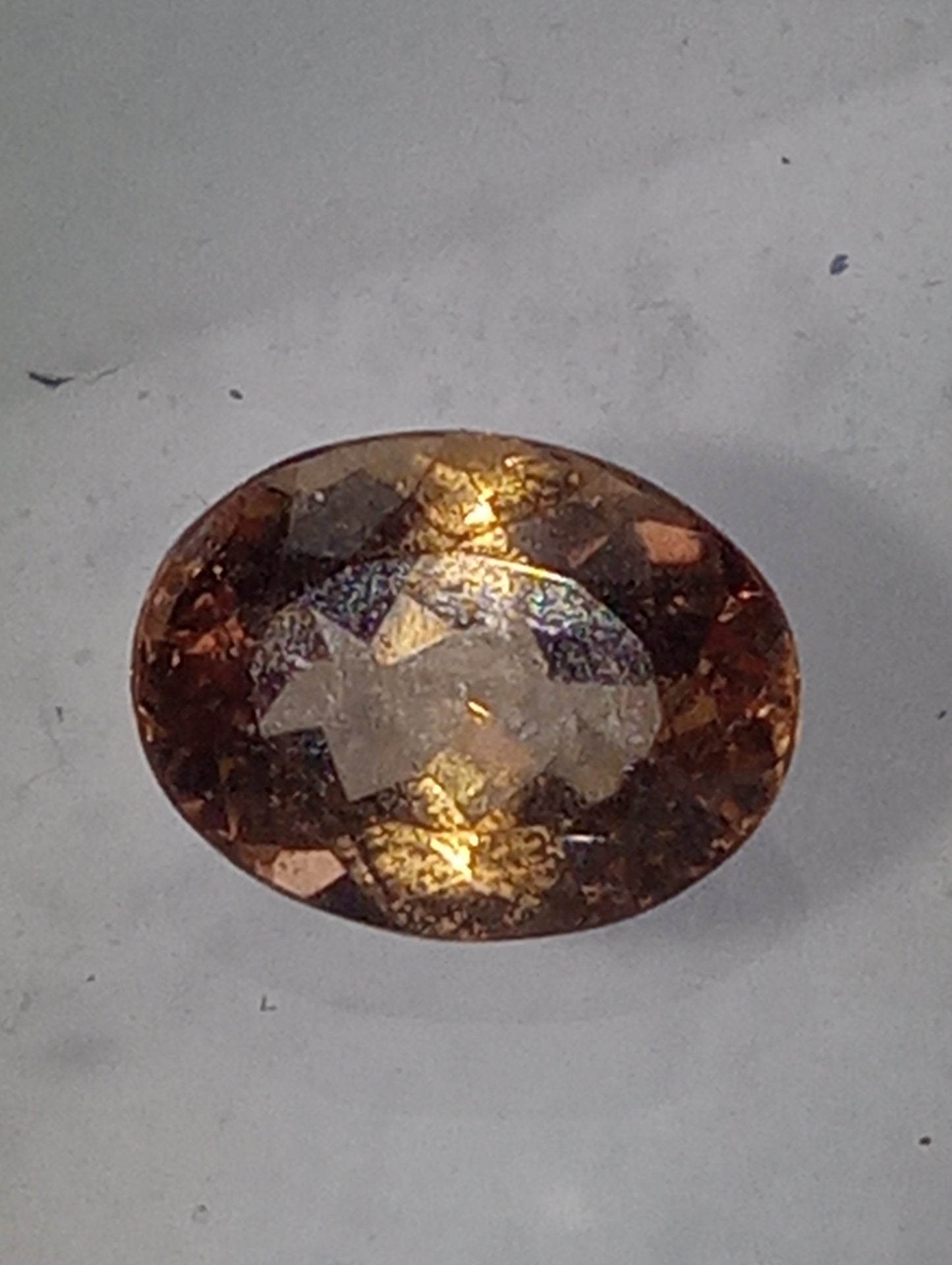 Topaz gemstone Imperial, golden with slightly pink undertones, 7mmx5.5mm oval cut, 1.07ct
