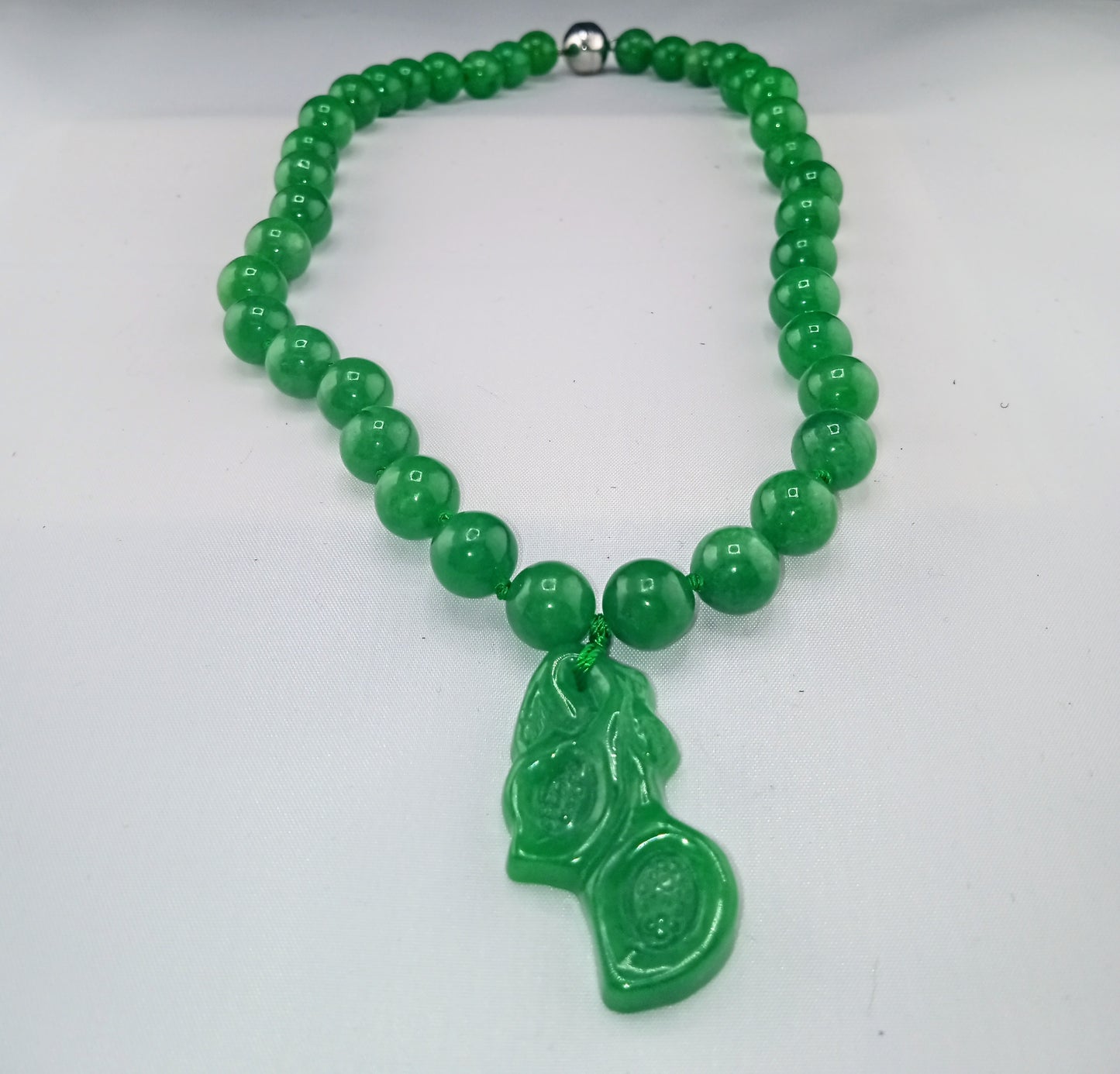 green jade necklace with carved green jade orchid