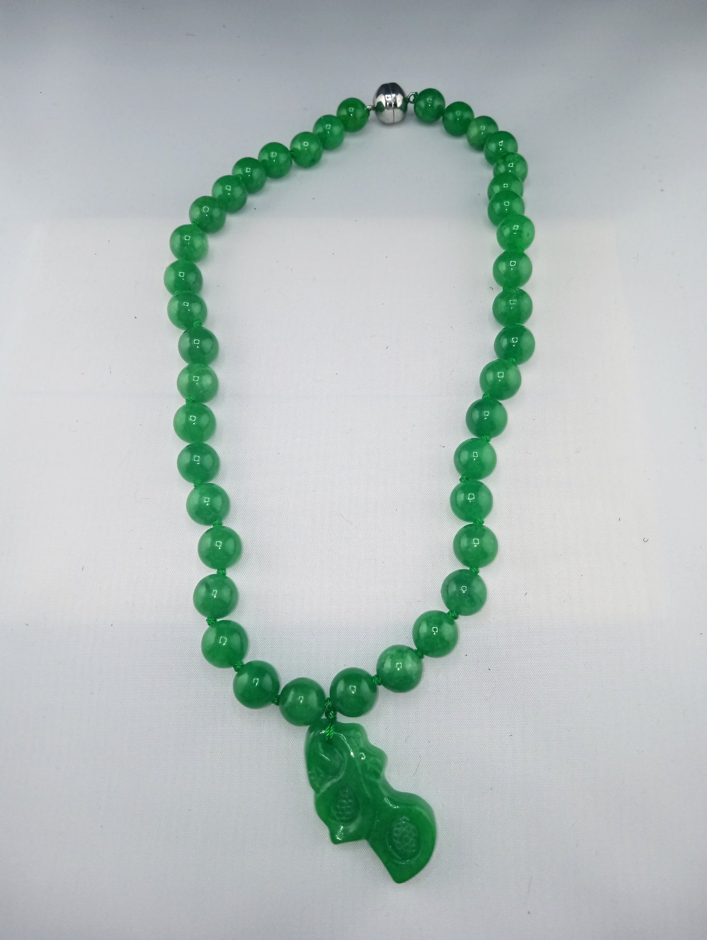 green jade necklace with carved green jade orchid