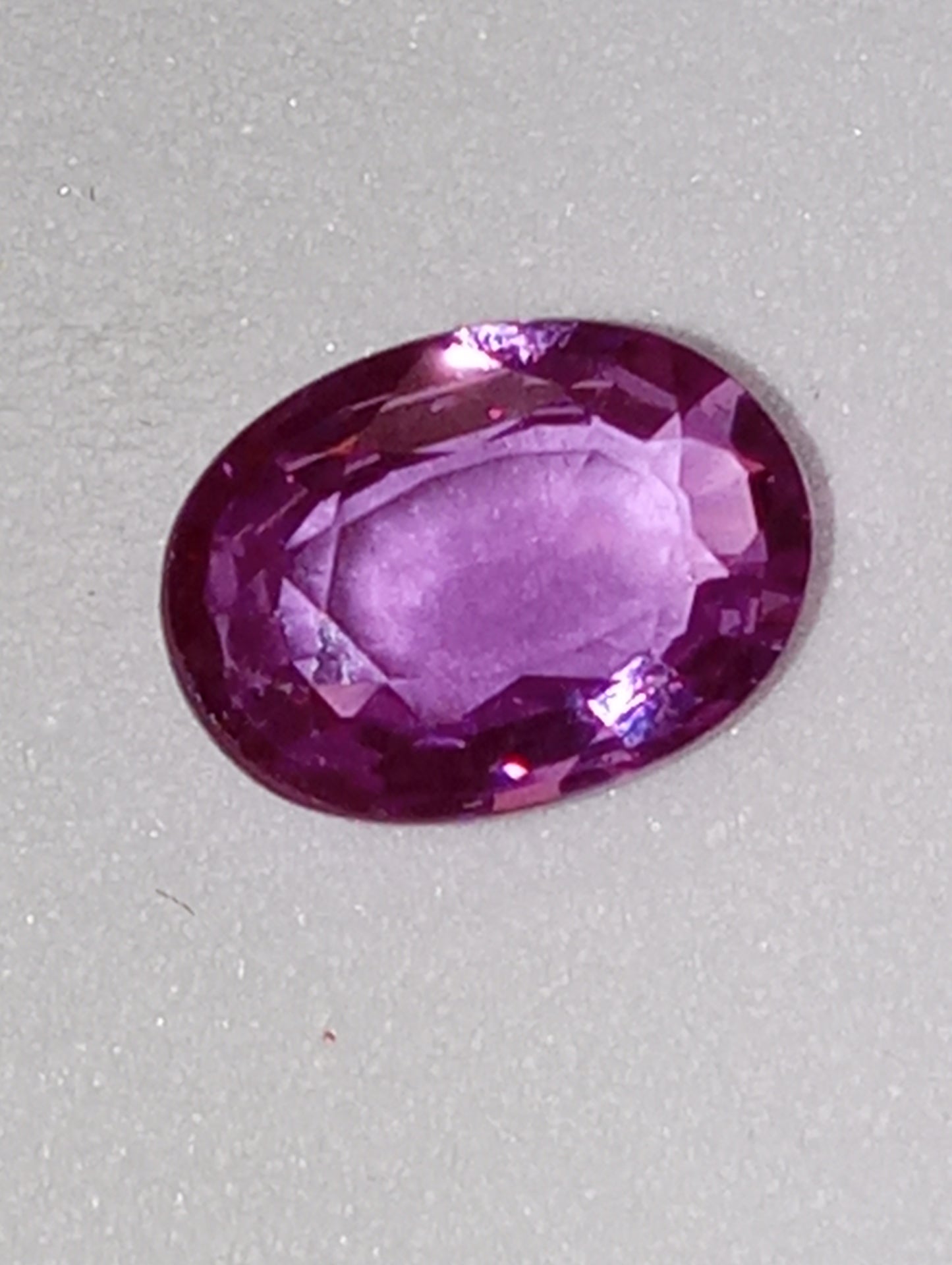 sapphire gemstone, pinky-purple,  7x5mm oval .92ct