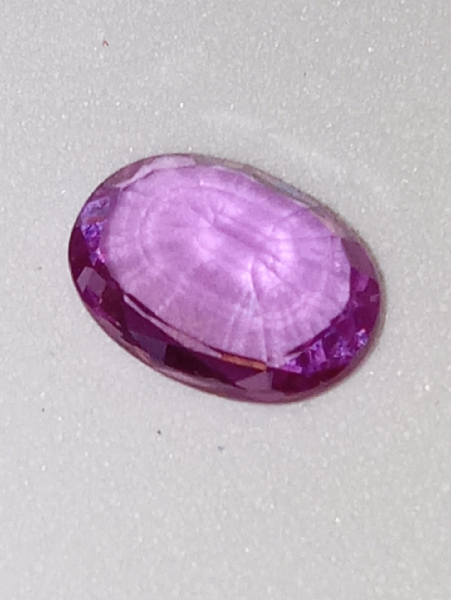 sapphire gemstone, pinky-purple,  7x5mm oval .92ct