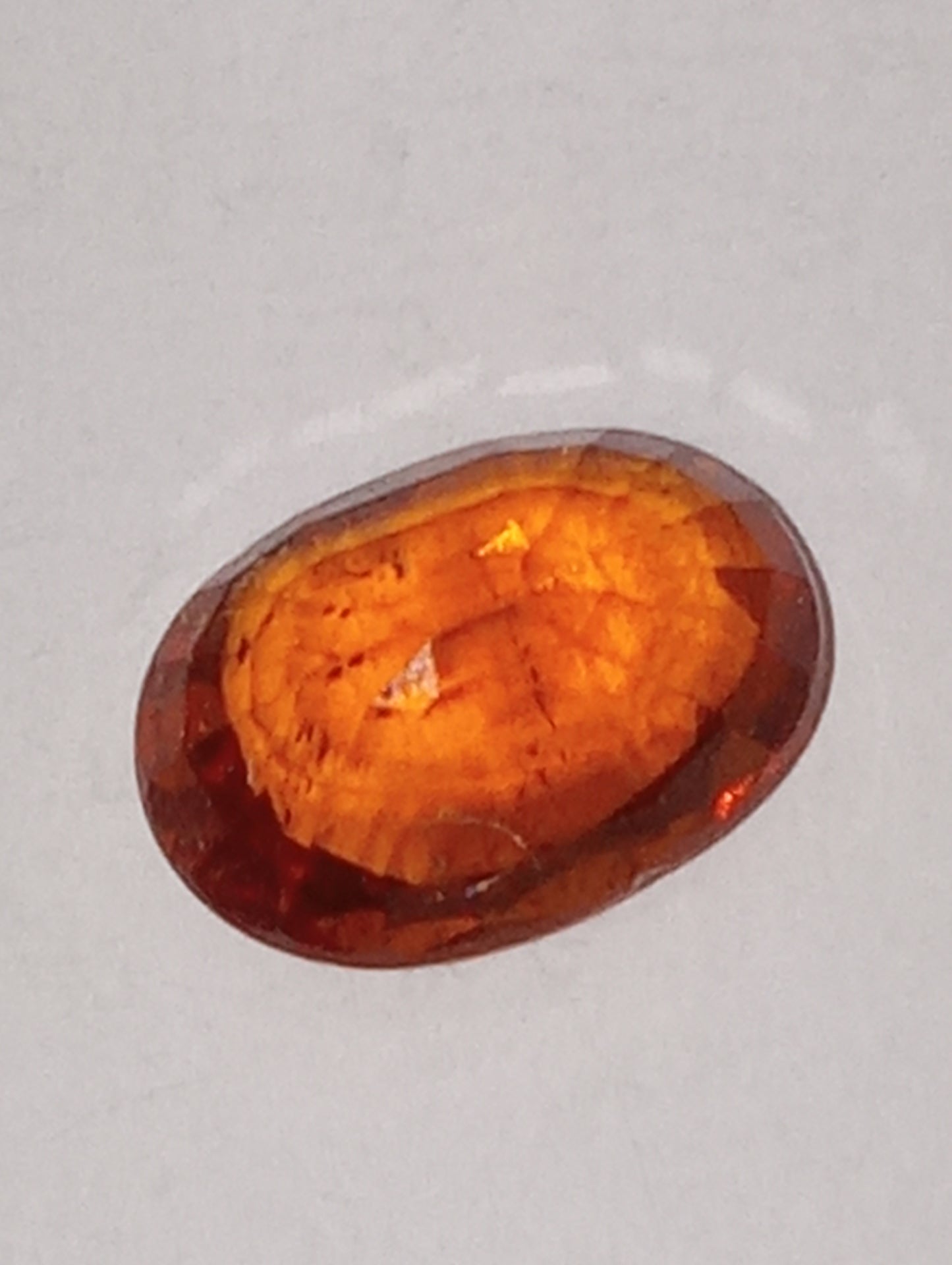 garnet gemstone mandarin spessartite, 7mmx5mm oval cut, 1.13ct