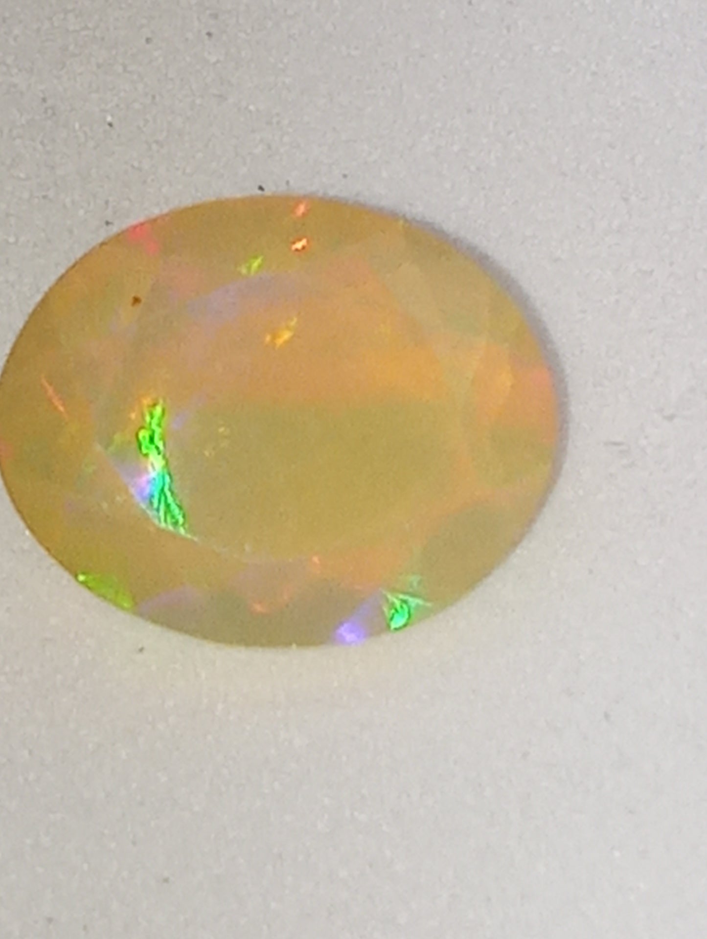 opal Ethiopian oval, 12mmx10mm faceted, orange flash, 1.75ct