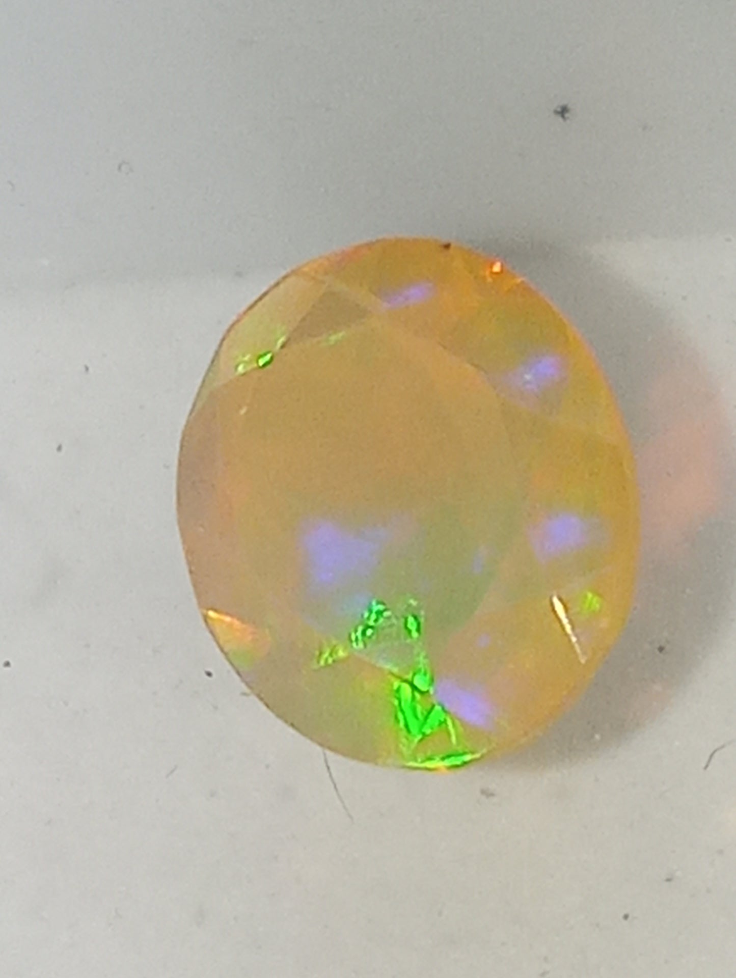 opal Ethiopian oval, 12mmx10mm faceted, orange flash, 1.75ct