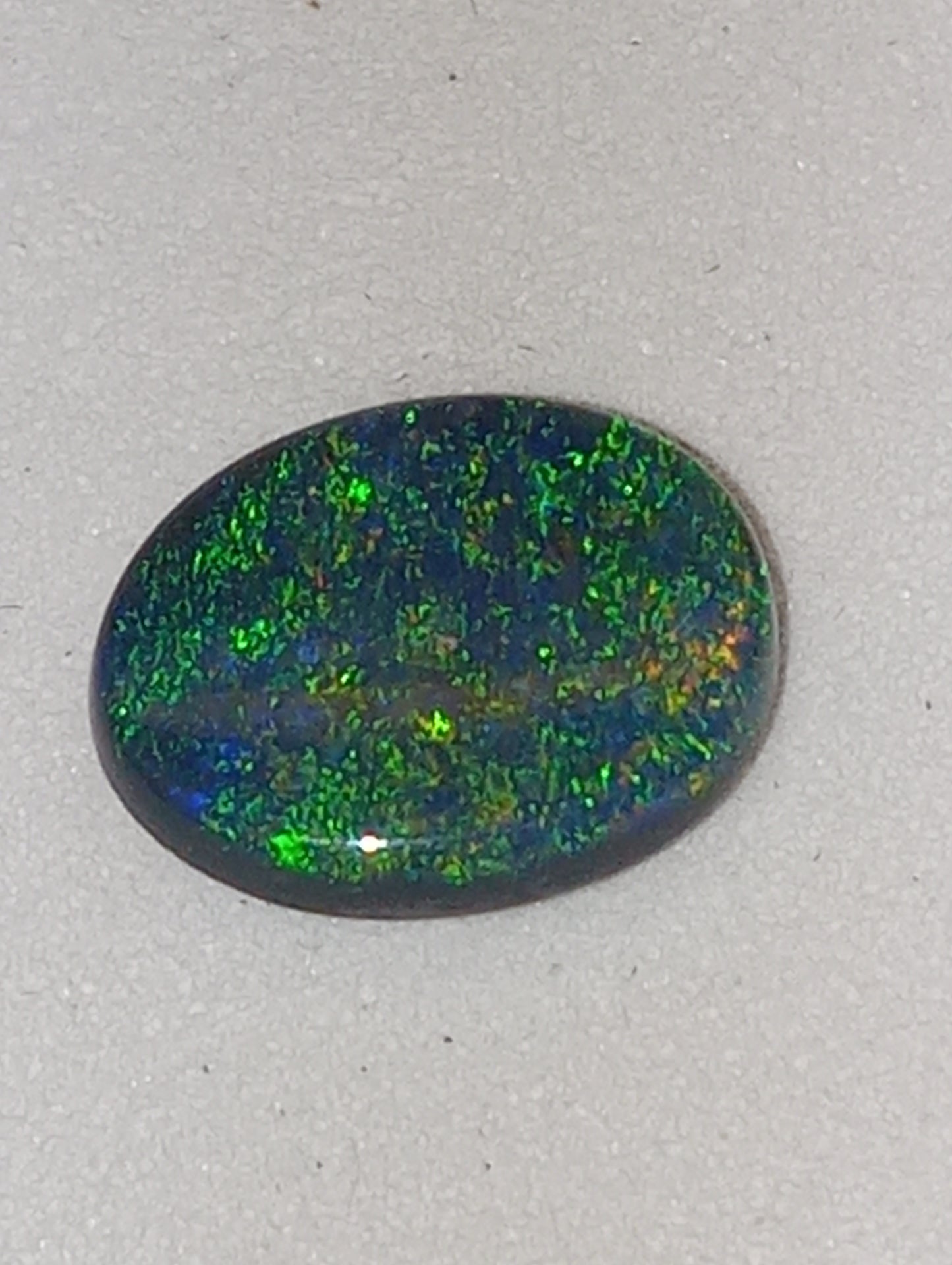 opal gemstone,  black Lightning Ridge .83ct,  8.5mmx6.5mm