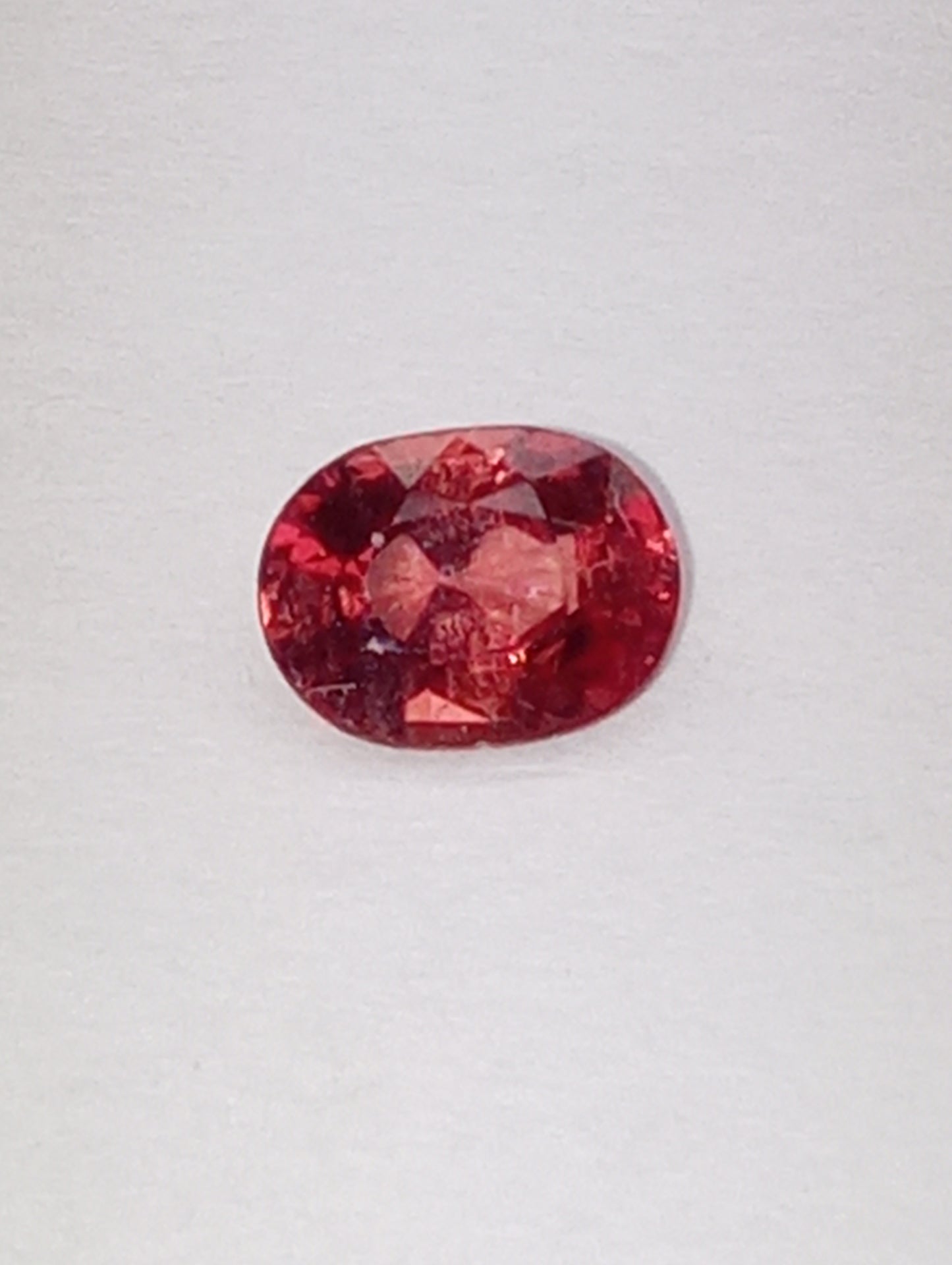 spinel gemstone Burmese, red orange, padparasha color, 6mmx5mm oval cut, .62ct