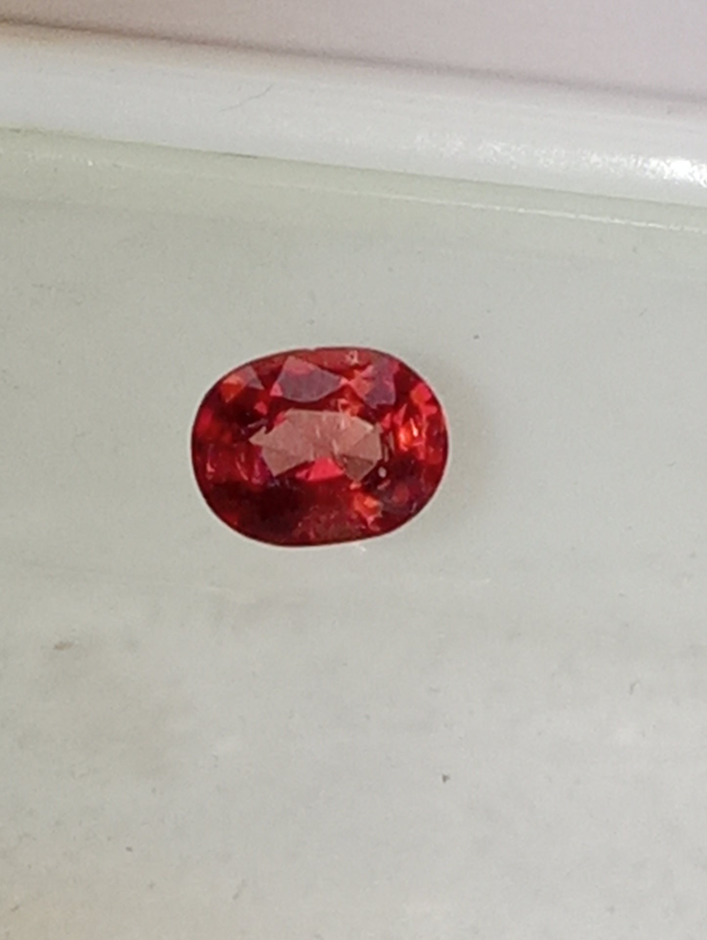 spinel gemstone Burmese, red orange, padparasha color, 6mmx5mm oval cut, .62ct
