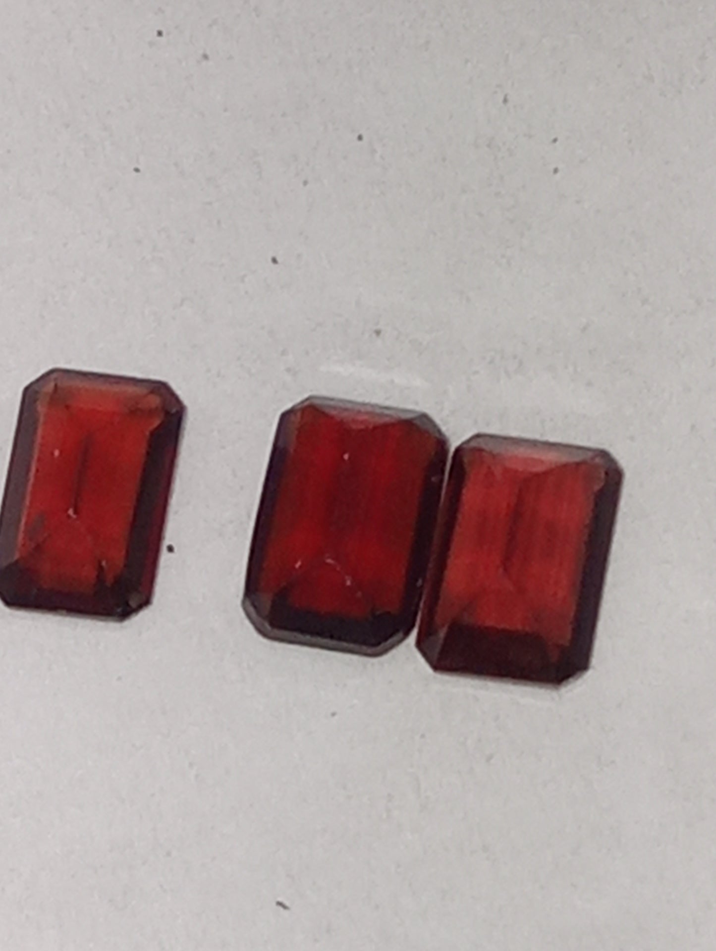 garnet gemstones, red, 6mmx4mm emerald cut, 3 stones