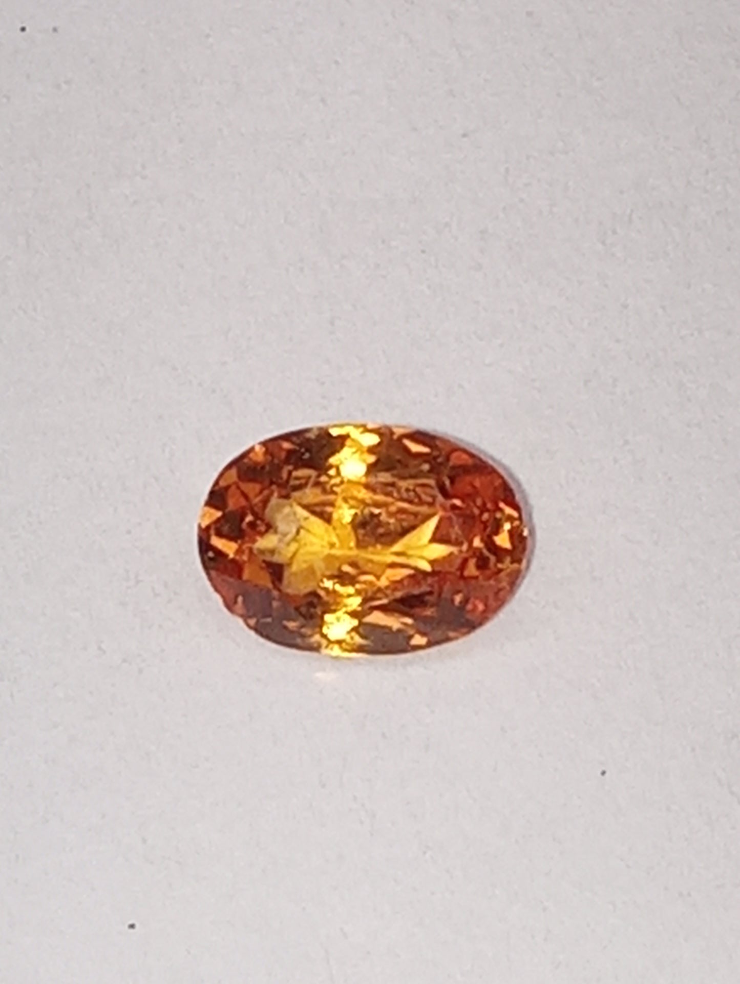 garnet gemstone, mandarin spessartite, 7mmx5mm oval cut, .76ct