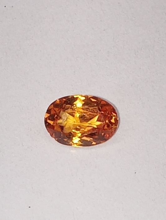 garnet gemstone, mandarin spessartite, 7mmx5mm oval cut, .76ct