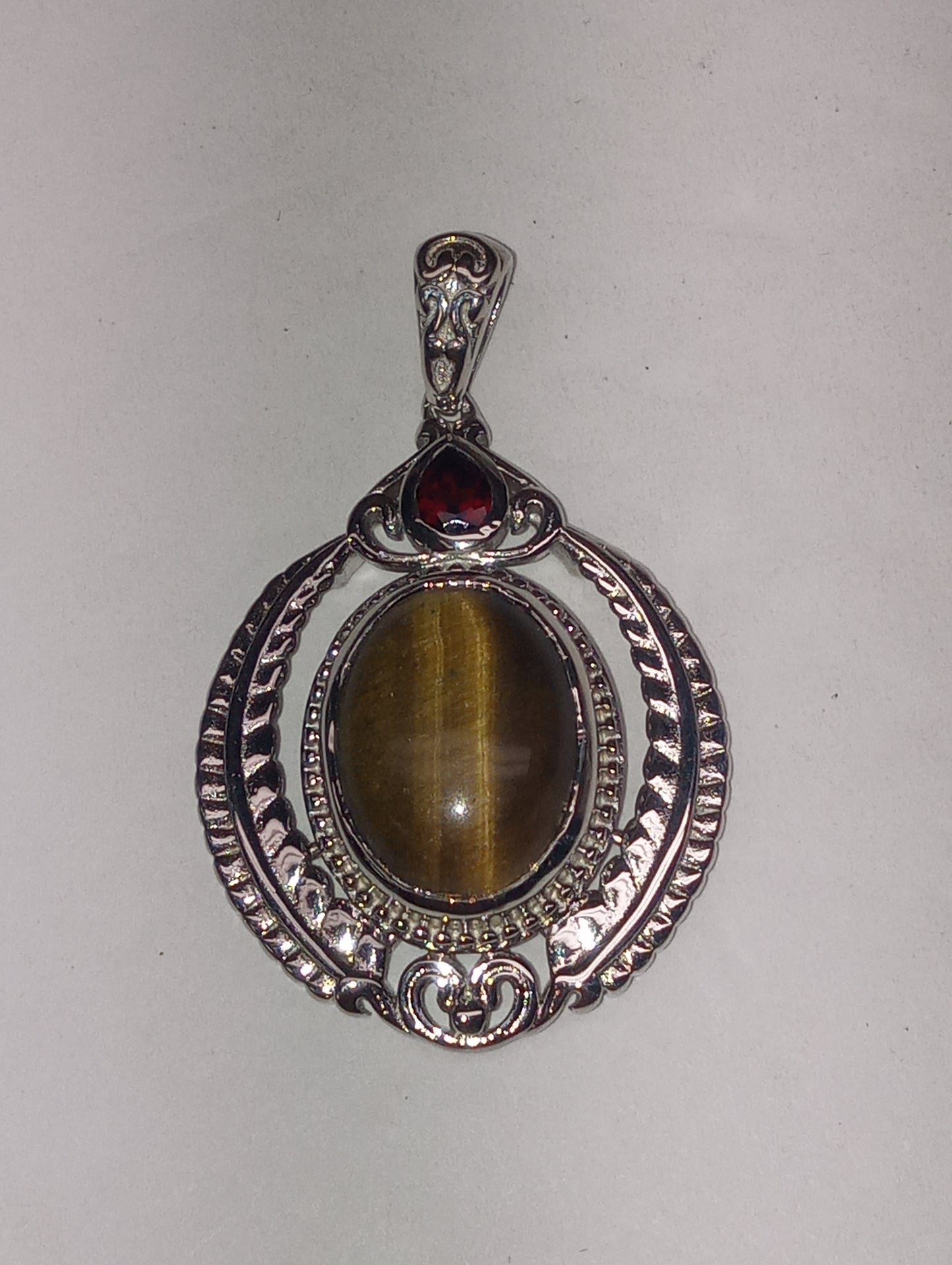 pendant tiger's eye, Mozembique garnet, in platinum over copper with magnet, 10.25ctw