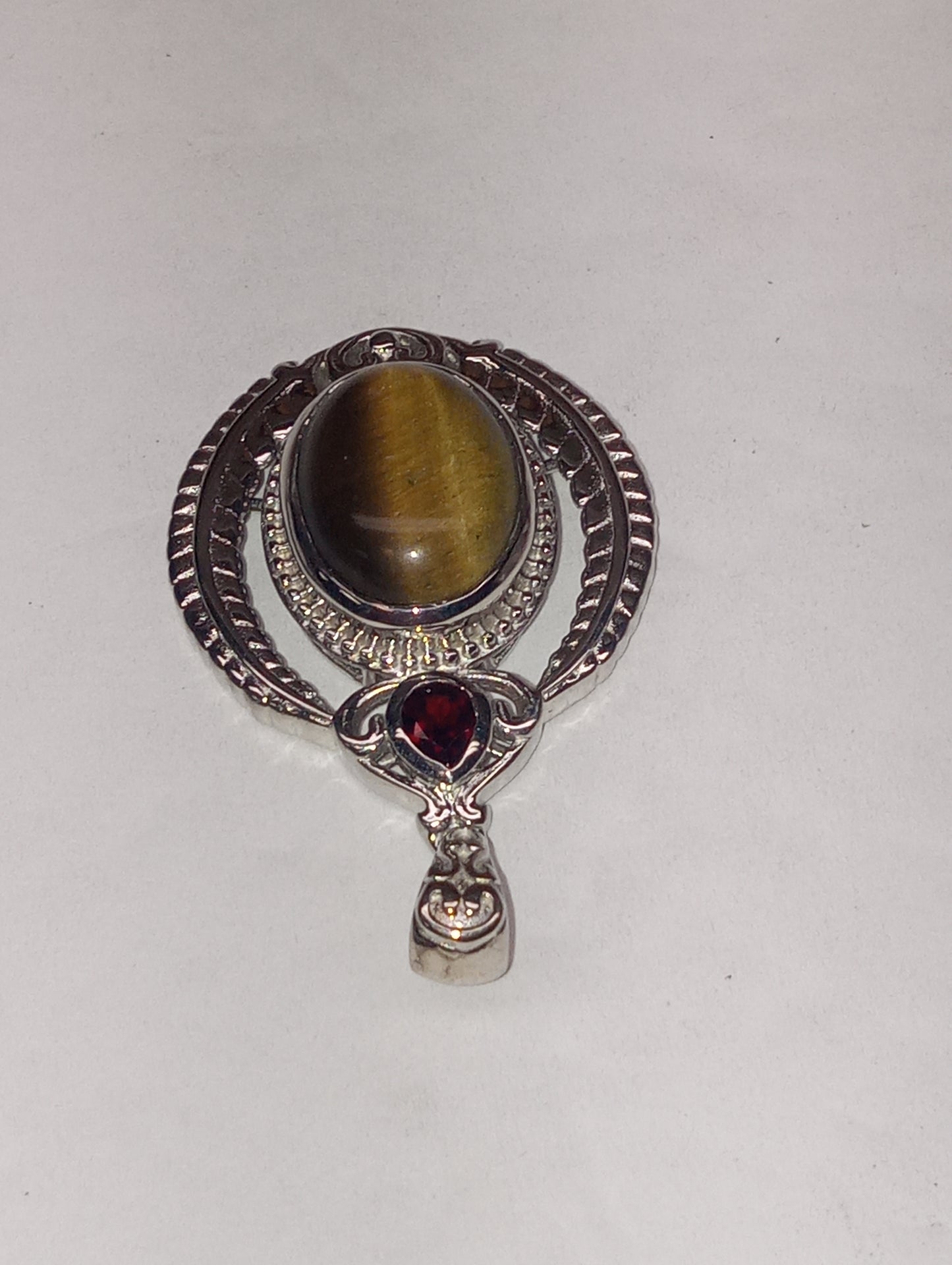 pendant tiger's eye, Mozembique garnet, in platinum over copper with magnet, 10.25ctw