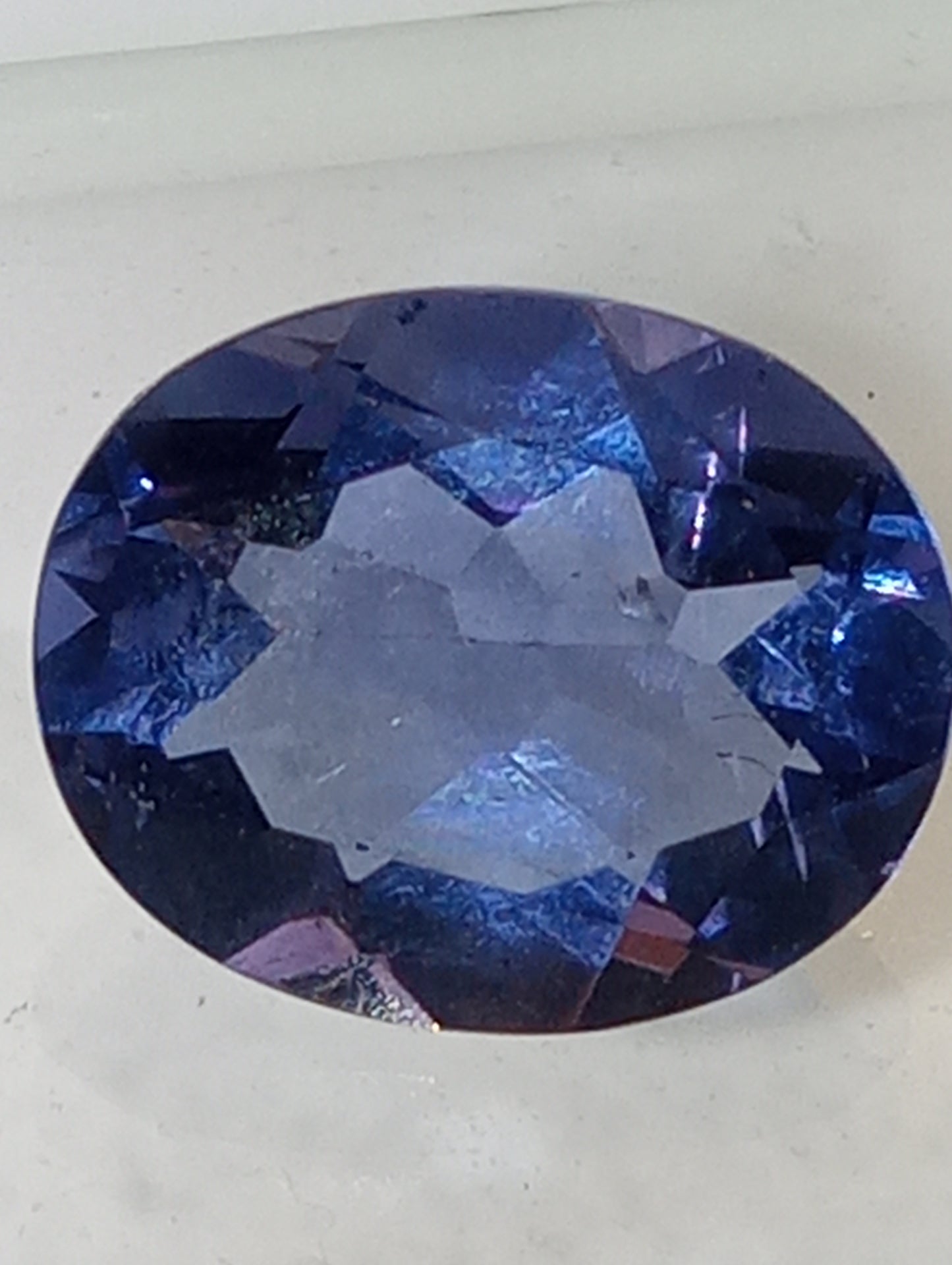 fluorite gemstone, blue-purple color shift, 11mmx9mm oval cut, 4.04ct