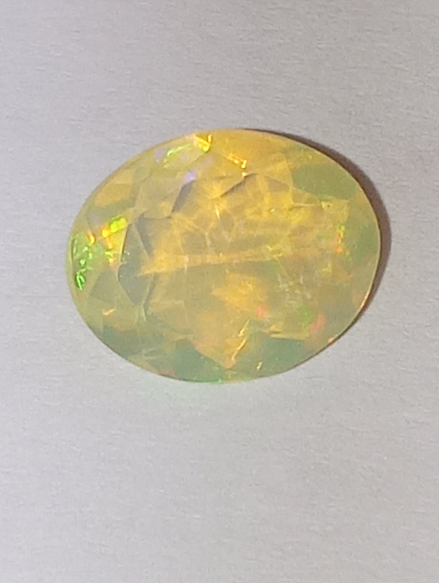 opal gemstone Ethiopian faceted 10mmx8mm oval cut, 1.32ct