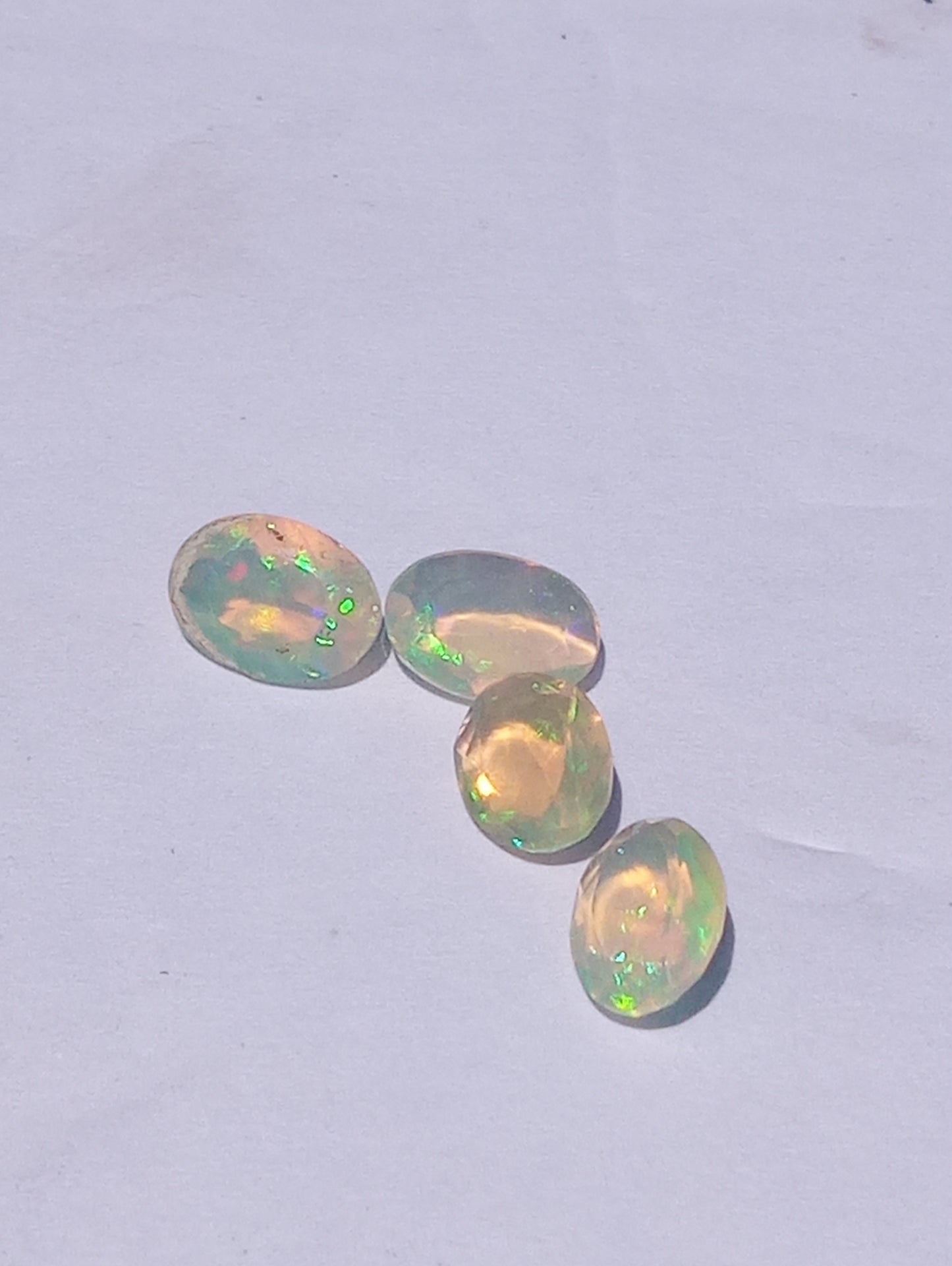 opal gemstones Ethiopian , faceted, 7mmx5mm oval cuts, 1.64ctw, 4 stones