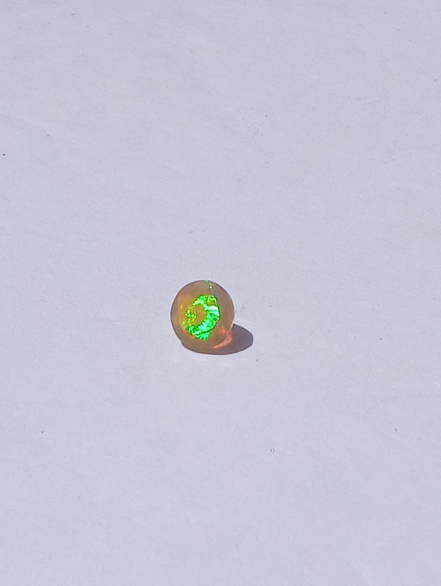 opal gemstone Ethiopian, faceted 7mm round cut, .79ct