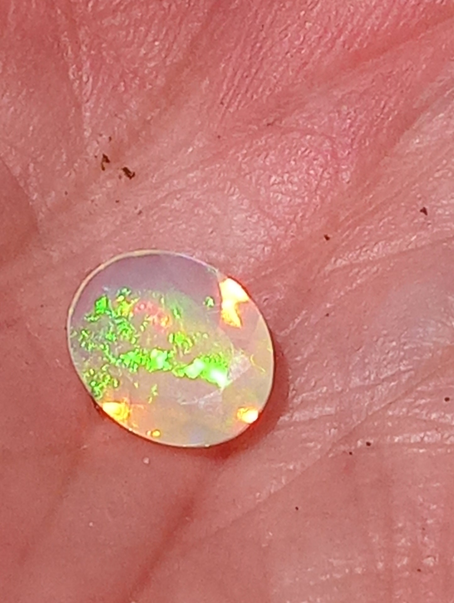 opal gemstone Ethiopian, faceted  9mmx7mm oval cut, .82ct