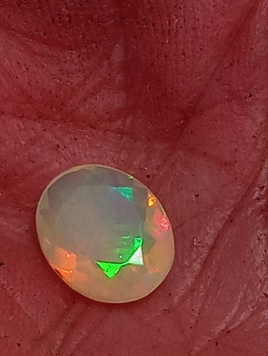 opal gemstone Ethiopian, faceted 10mmx8mm oval cut, 1.09ct