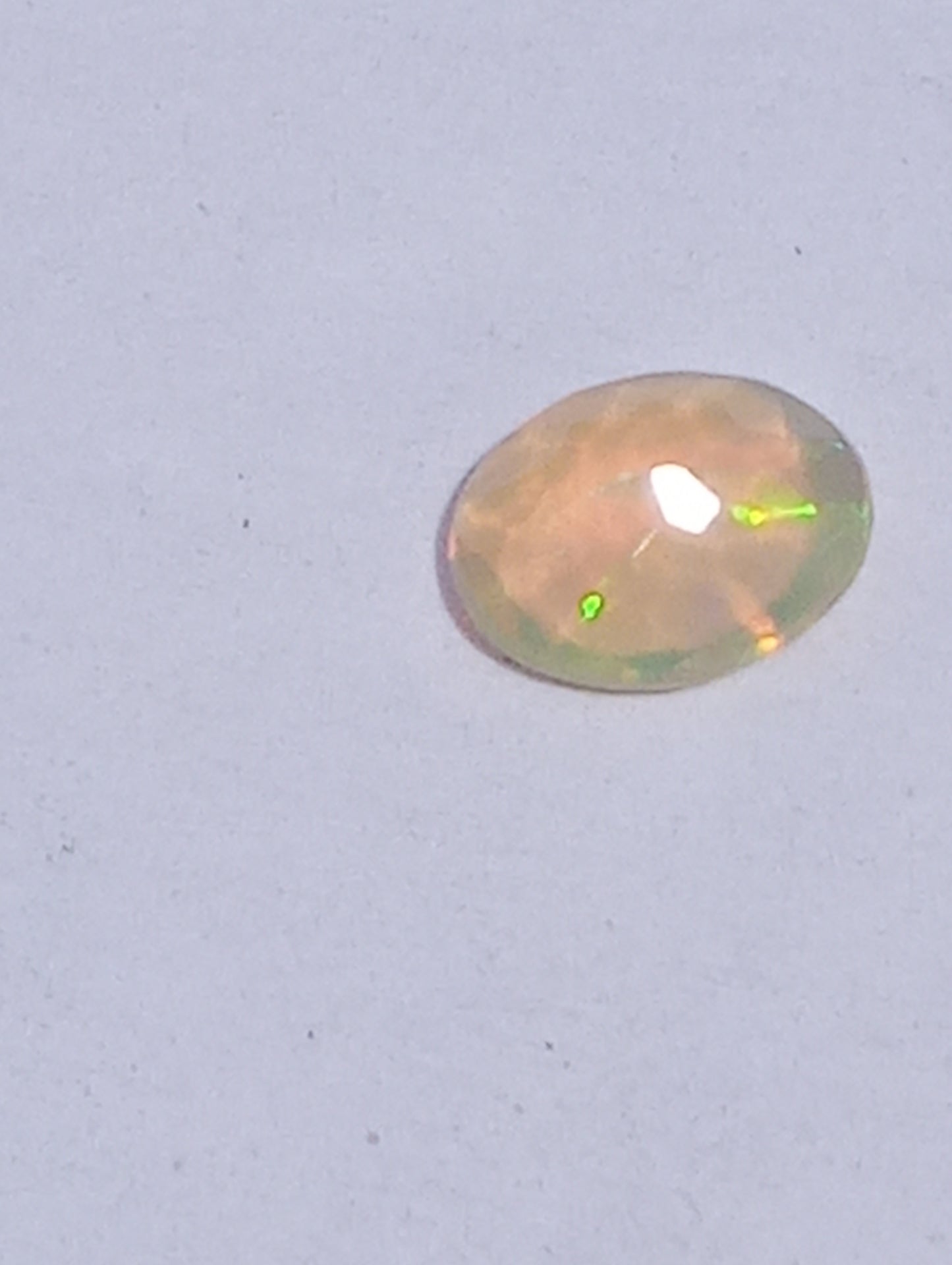 opal gemstone Ethiopian, faceted 10mmx8mm oval cut, 1.09ct