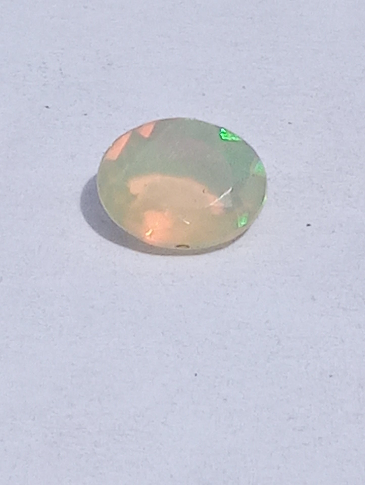 opal gemstone Ethiopian, faceted 10mmx8mm oval cut, 1.09ct