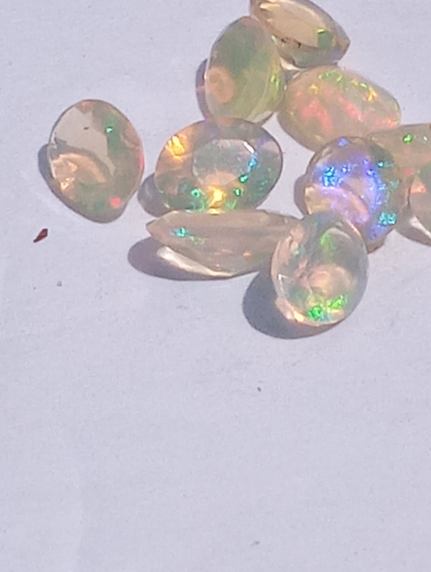 opal gemstones Ethiopian, faceted 7mmx5mm oval cuts, 10 stones