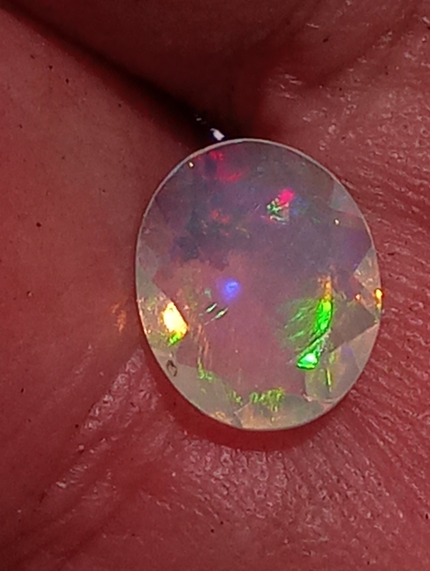 opal gemstone Ethiopian, faceted 10mmx8mm oval cut, 1.08cty