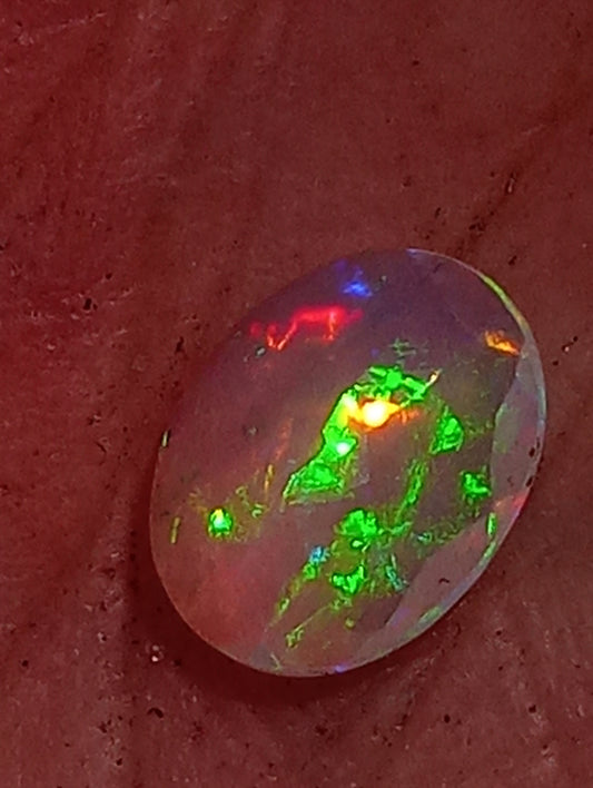 opal gemstone Ethiopian, faceted 10mmx8mm oval cut, 1.08cty
