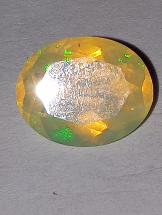 opal gemstone Ethiopian , faceted, 10mmx8mm oval, 1.83ct