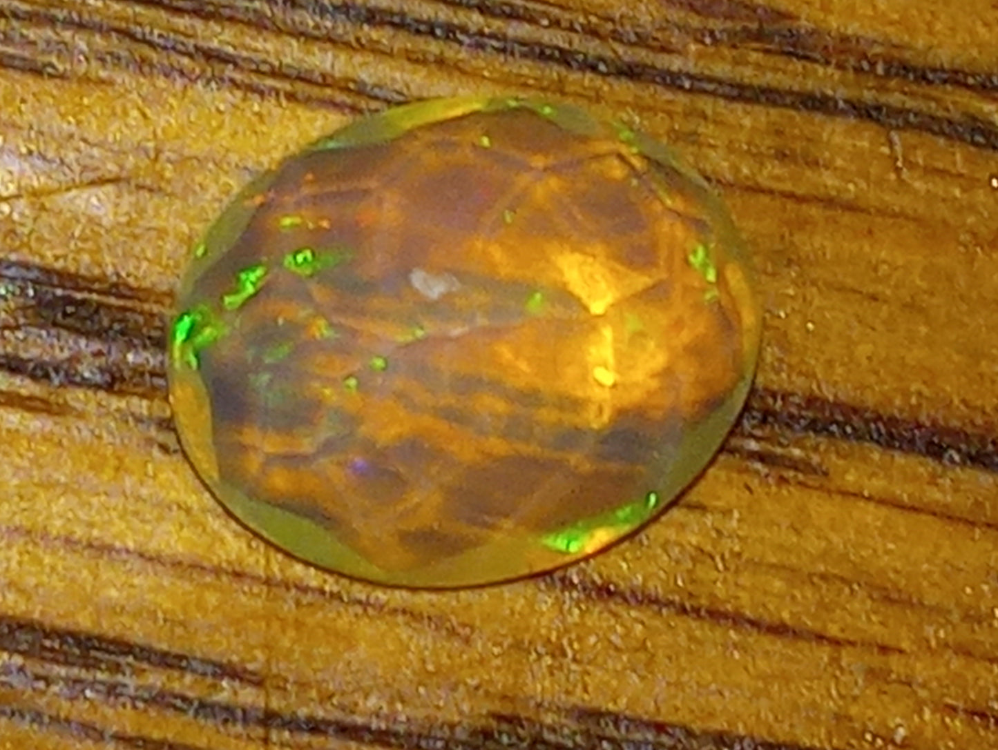 opal gemstone Ethiopian , faceted, 10mmx8mm oval, 1.83ct