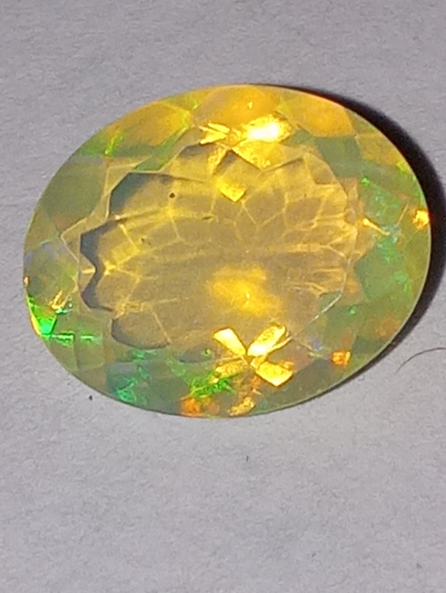 opal gemstone Ethiopian, faceted, 10mmx8mm oval cut, 1.71ct