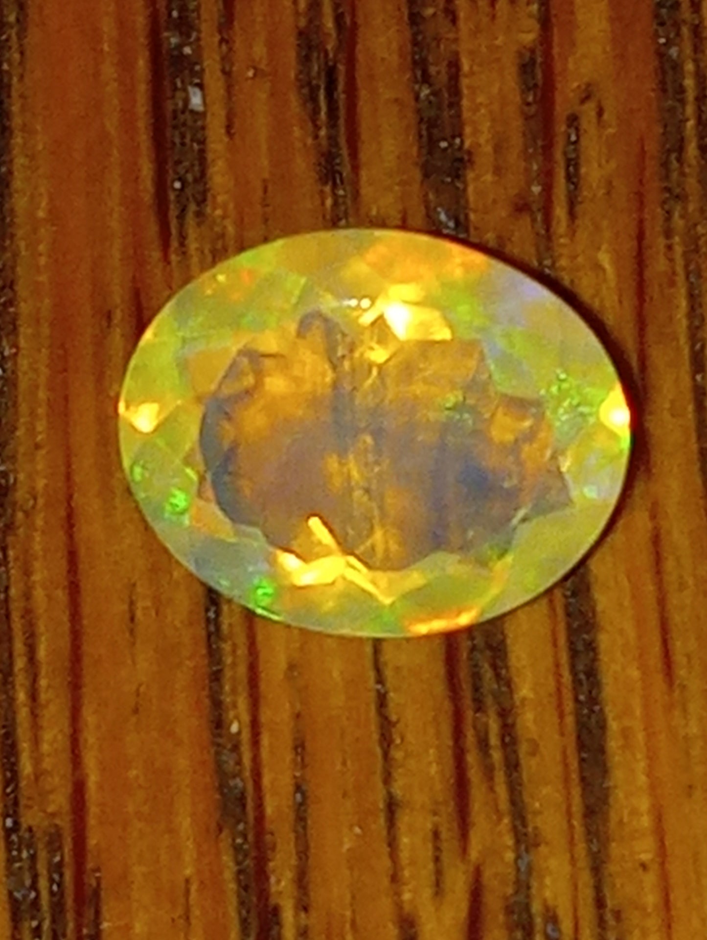 opal gemstone Ethiopian, faceted, 10mmx8mm oval cut, 1.71ct