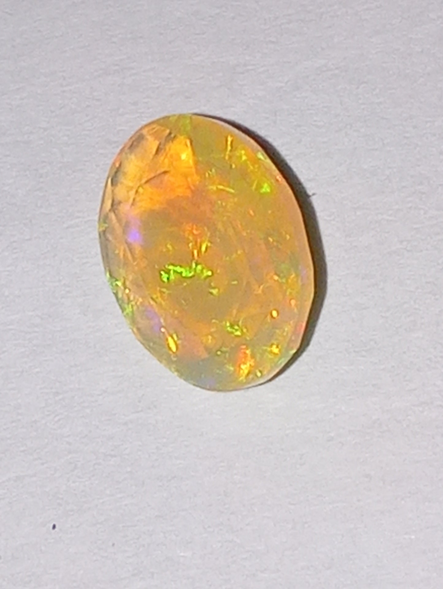 opal gemstone, Ethiopian, faceted, 9mmx7mm oval cut, 1.03ct
