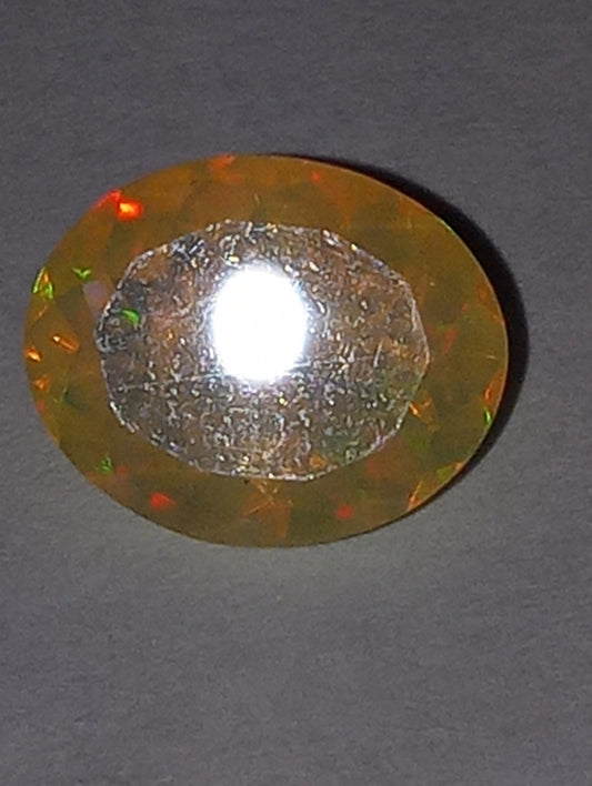 opal gemstone Ethiopian, faceted, 10mm x8mm oval, 1.53ct