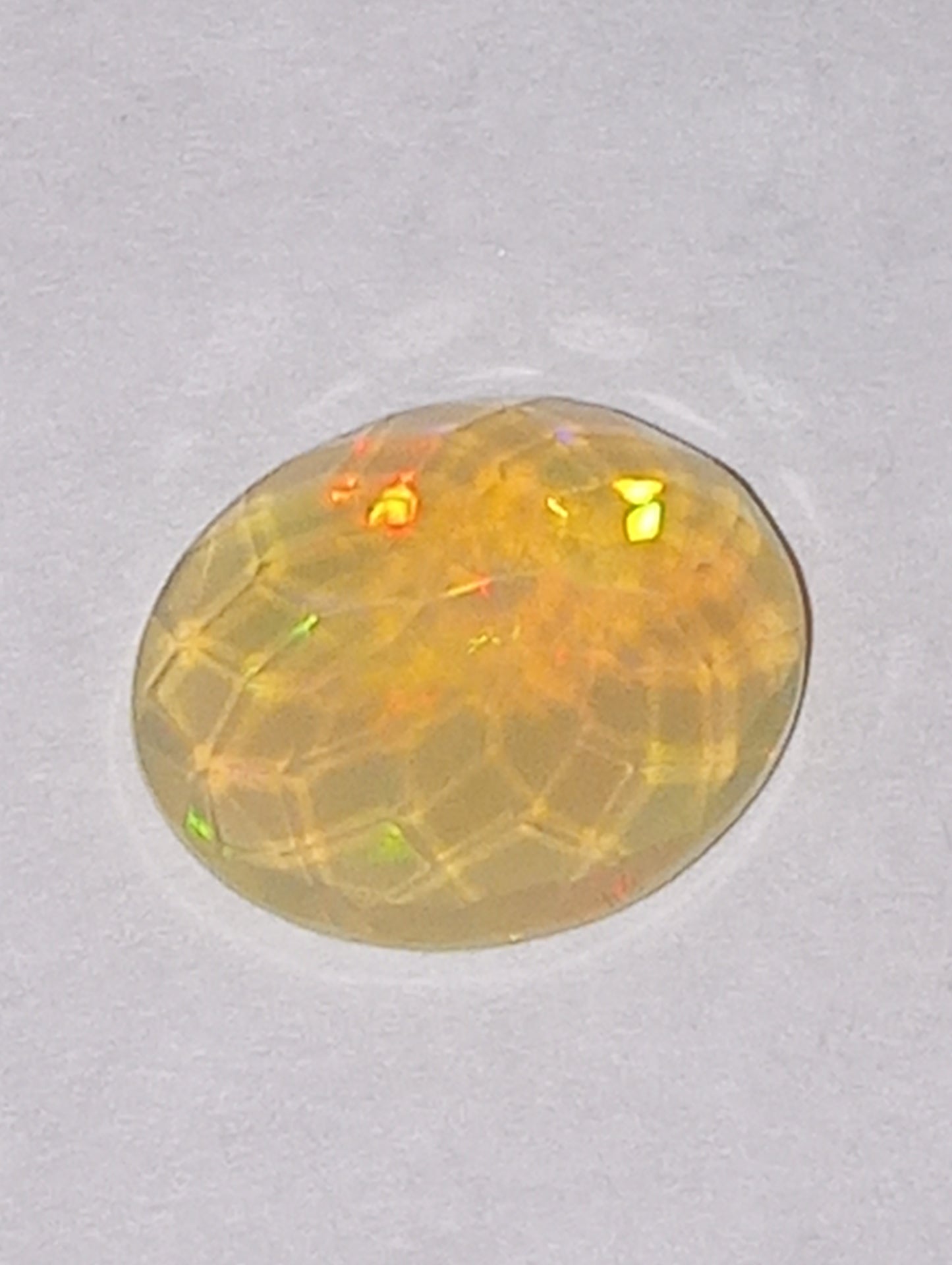opal gemstone Ethiopian, faceted, 10mm x8mm oval, 1.53ct