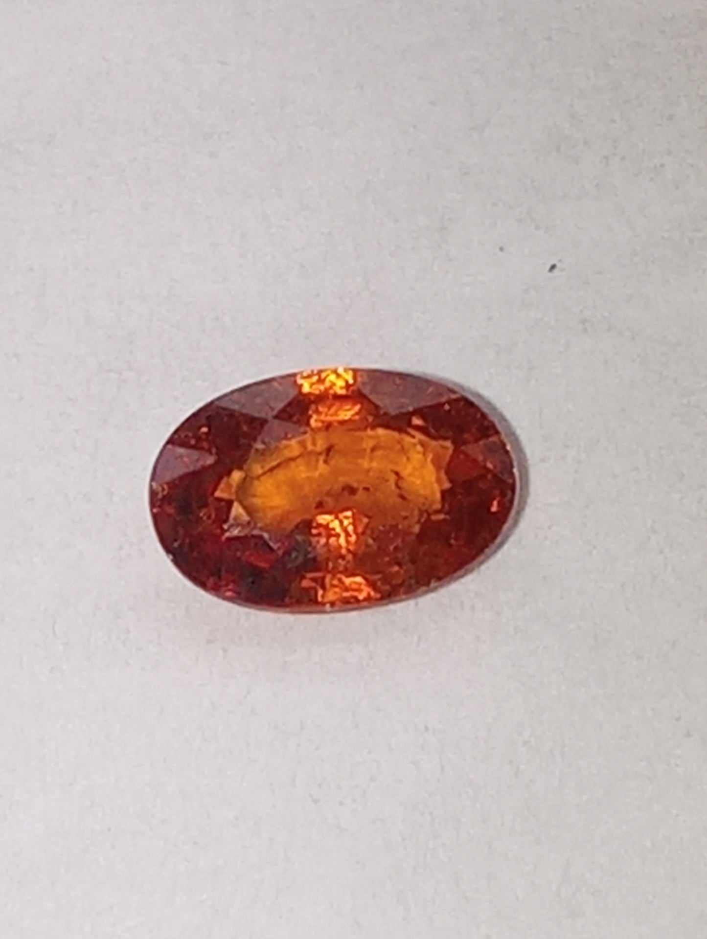 garnet gemstone Spessartite, 6mm x4mm oval cut, .62ct