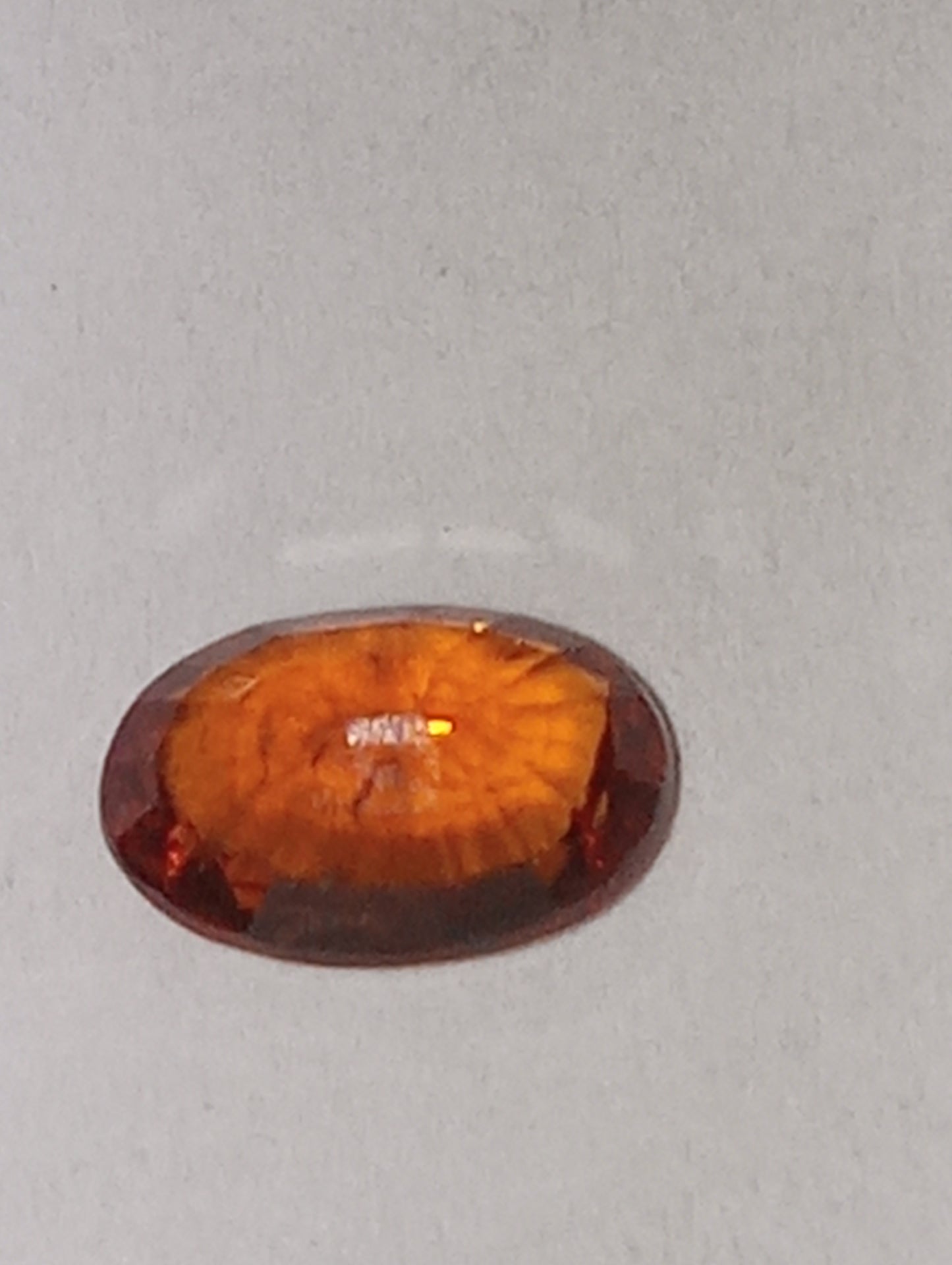 garnet gemstone Spessartite, 6mm x4mm oval cut, .62ct