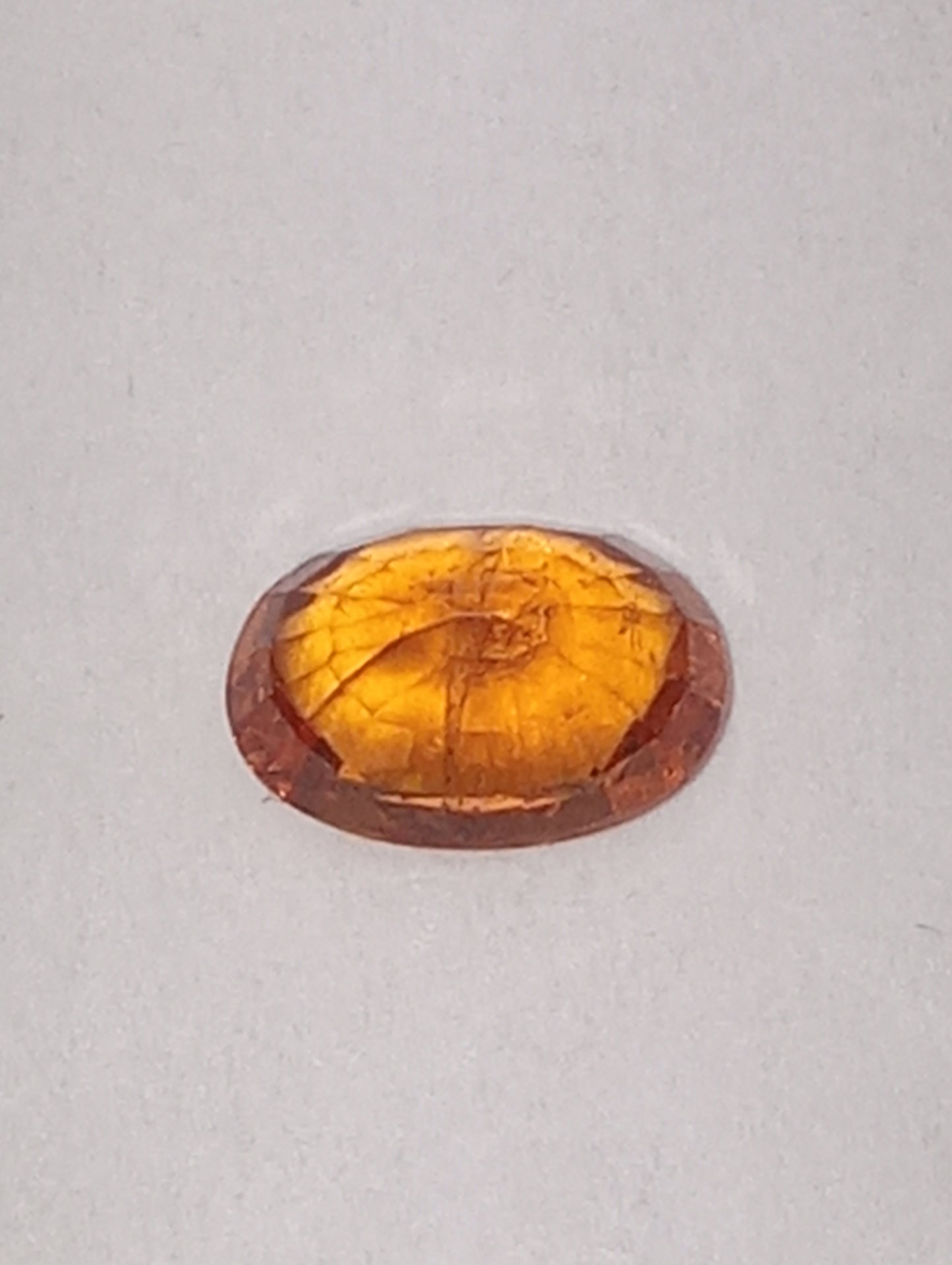 garnet gemstone spessartite, 6mmx4mm oval cut, .70ct