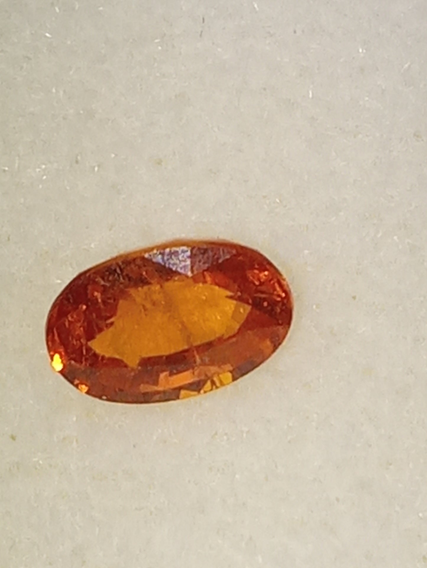 garnet gemstone spessartite, 6mmx4mm oval cut, .70ct