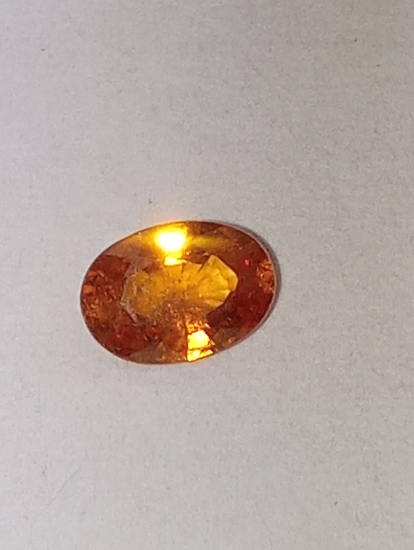garnet gemstone mandarin spessartite, 6mmx4mm oval cut, .60ct